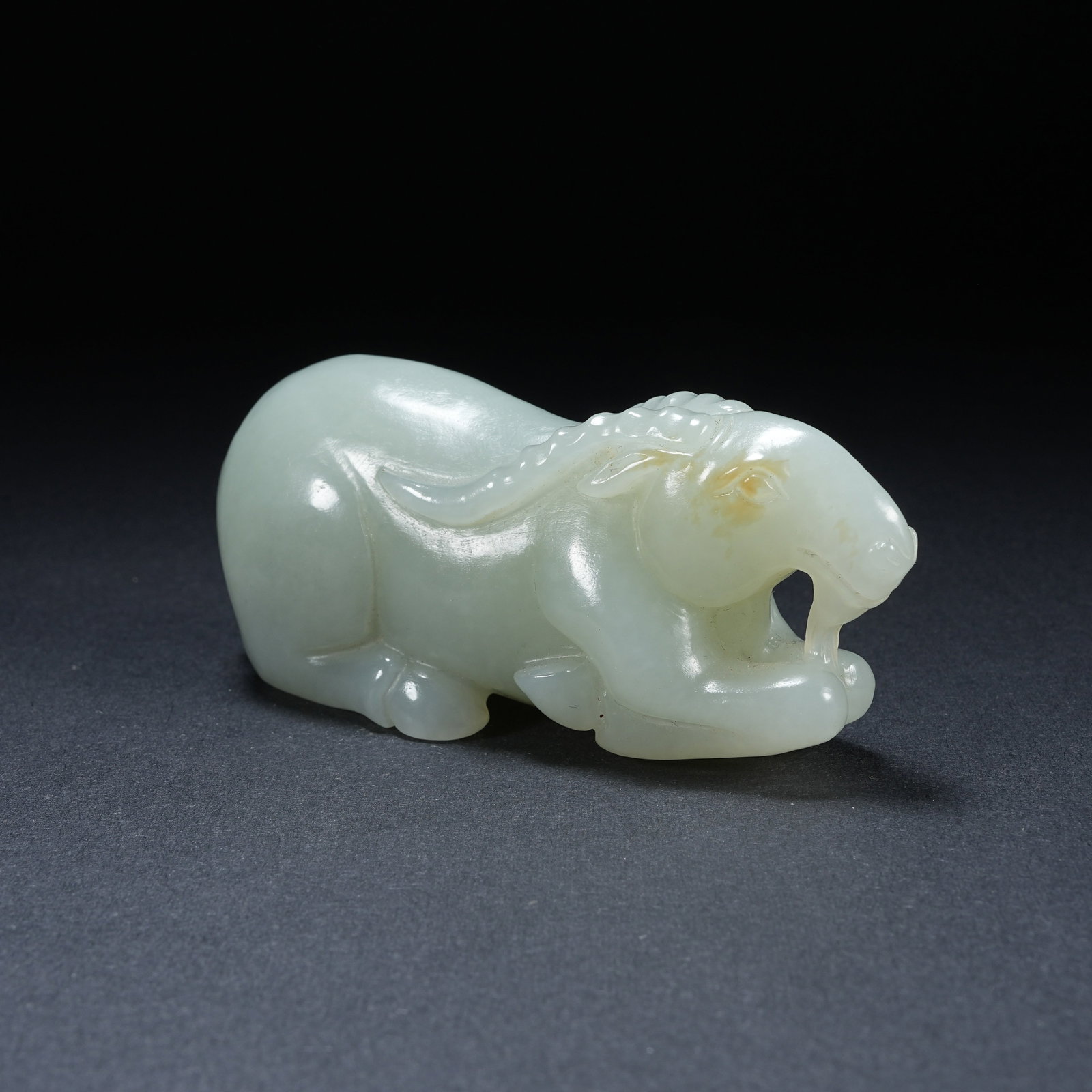 A HETIAN JADE RECLINING GOAT ORNAMENT: Hetian Jade Reclining Goat Ornament