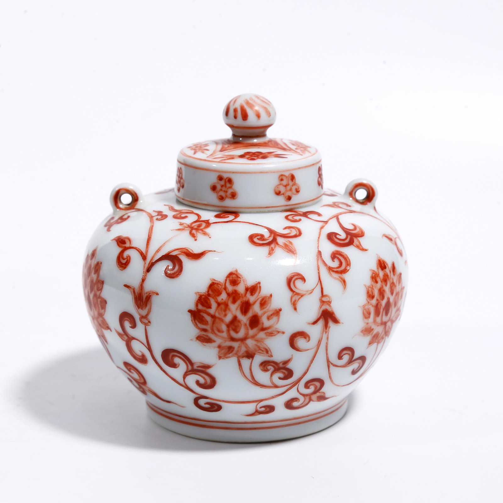 A IRON RED COVERED JAR WITH INTERLOCKING FLORAL PATTERNS (1 of 10)