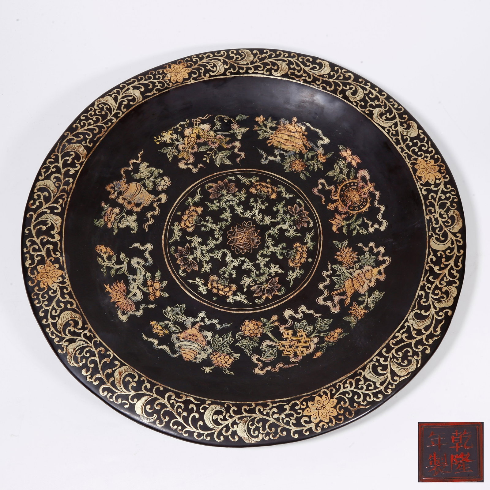 A LACQUERED GILDED PLATE WITH EIGHT TREASURES PATTERNS: Lacquered Gilded Plate with Eight Treasures Patterns