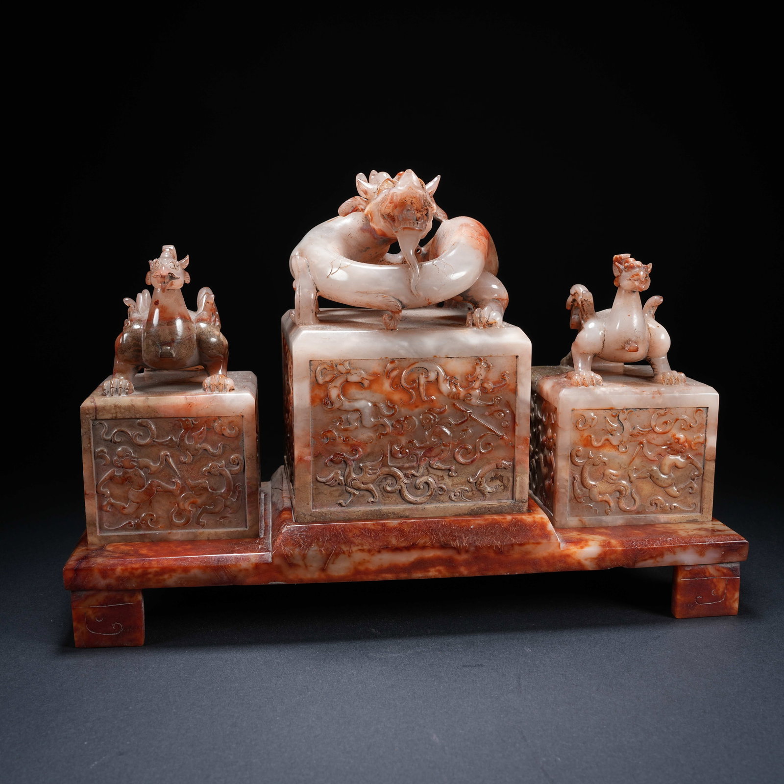 A SET OF ANCIENT JADE COMBINED FOUR-PIECE SEALS WITH ONE DRAGON AND TWO PHOENIXES CARVED WITH: Set of Ancient Jade Combined Four-piece Seals with One Dragon and Two Phoenixes Carved with Hunting Scene