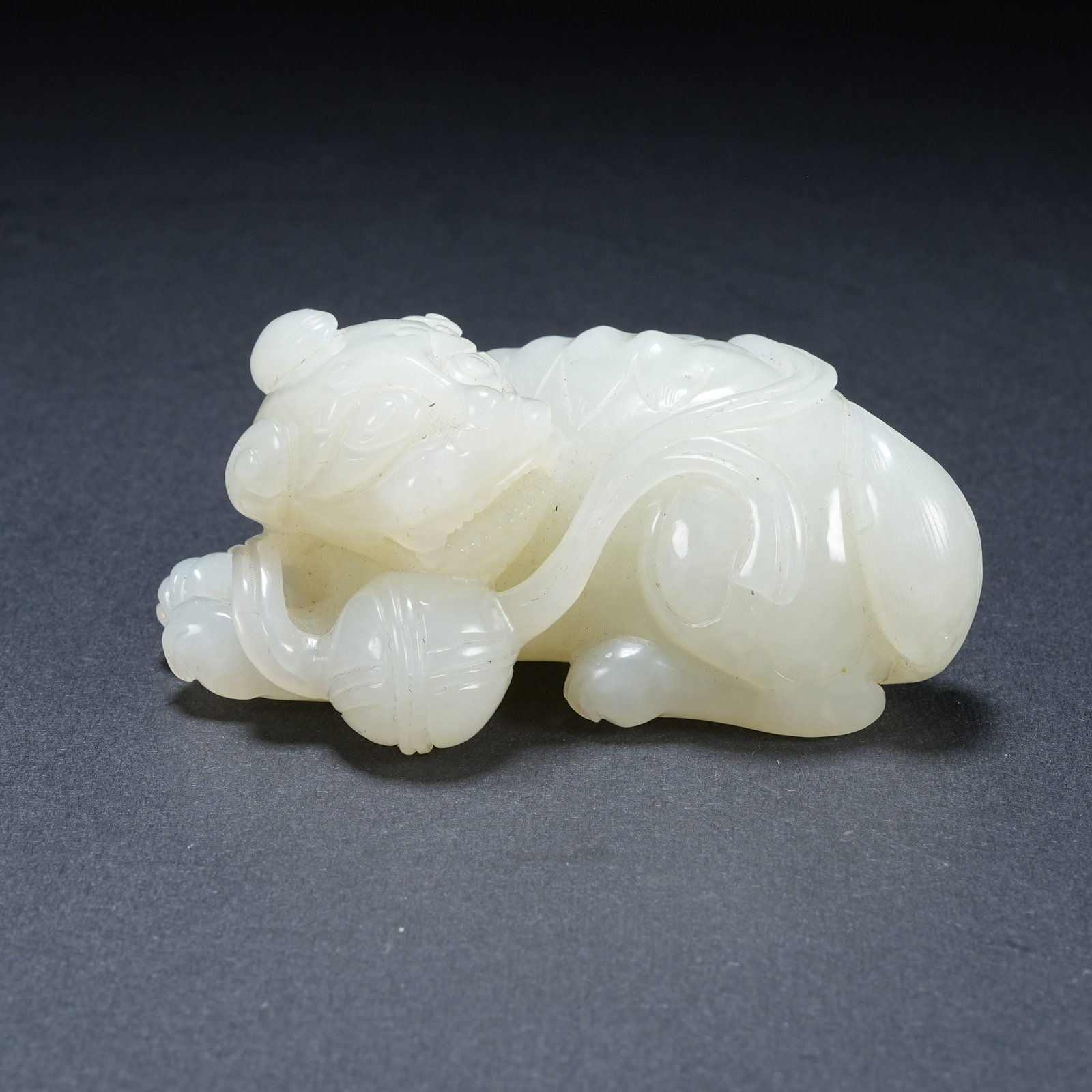 A HETIAN JADE ORNAMENT OF LIONS PLAYING WITH SILK BALLS: Hetian Jade Ornament of Lions Playing with Silk Balls