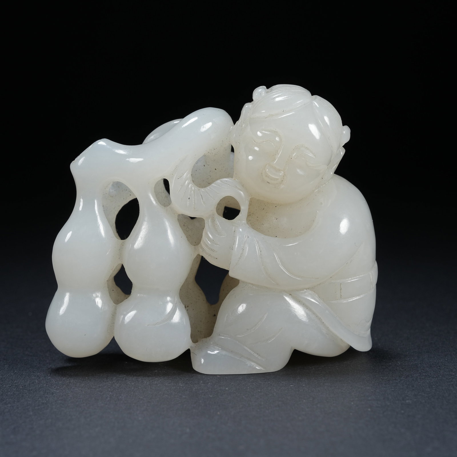A HETIAN JADE ORNAMENT OF BOY WITH GOURD: Hetian Jade Ornament of Boy with Gourd