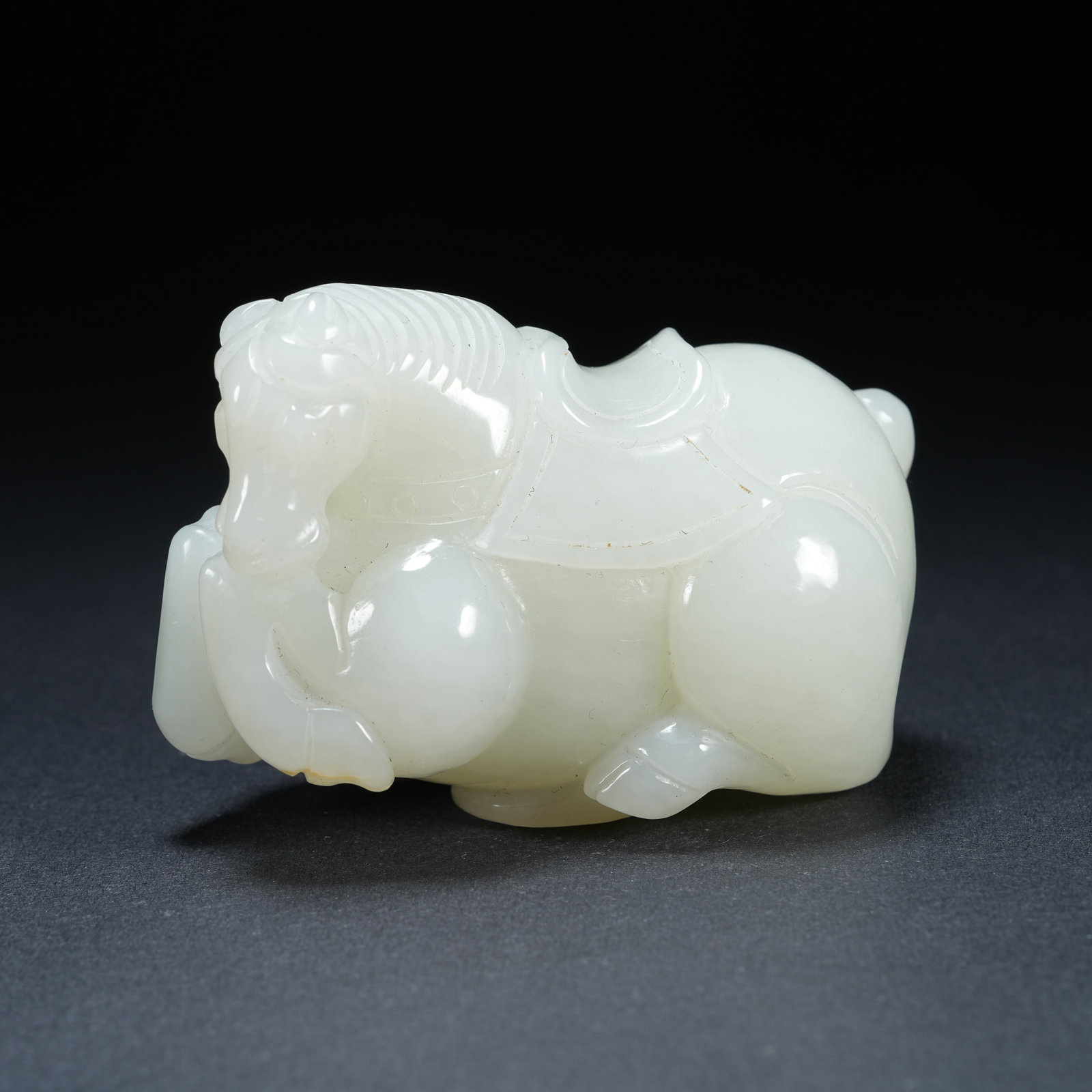 A HETIAN JADE RECLINING HORSE HAND PIECE: Hetian Jade Reclining Horse Hand Piece