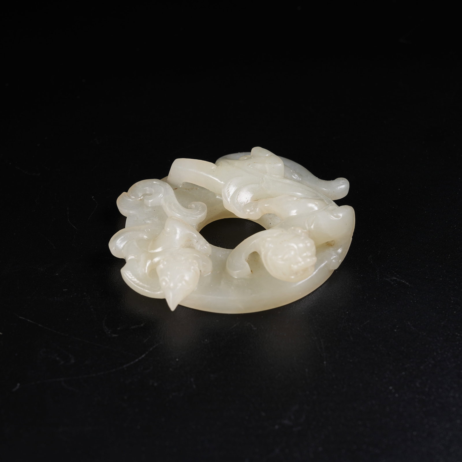 A HETIAN JADE BI DISC WITH OUTER RELIEF CHI DRAGON PATTERNS: Hetian Jade Bi Disc with Outer Relief Chi Dragon Patterns
