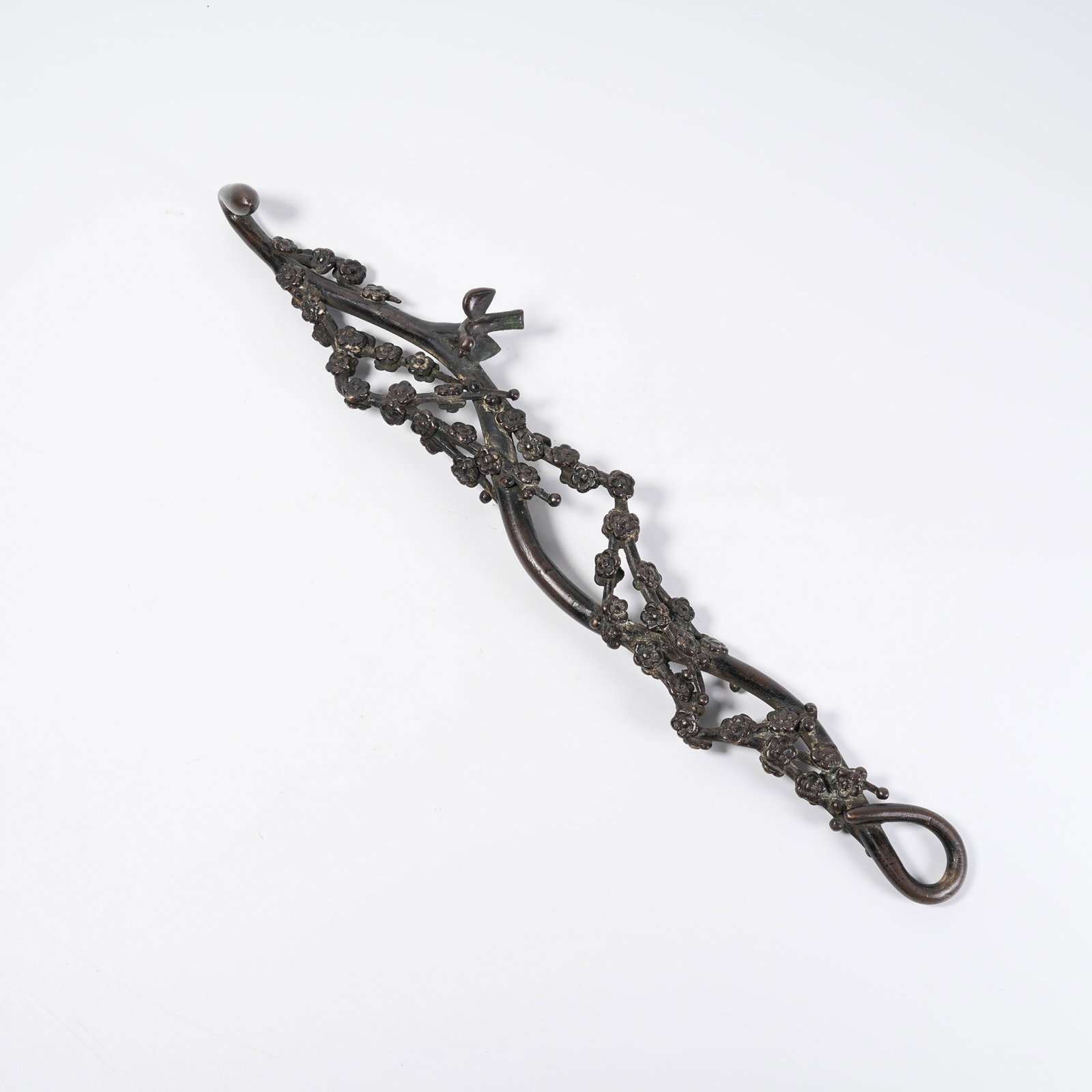 A BRONZE FLORAL ORNAMENT: Bronze Floral Ornament