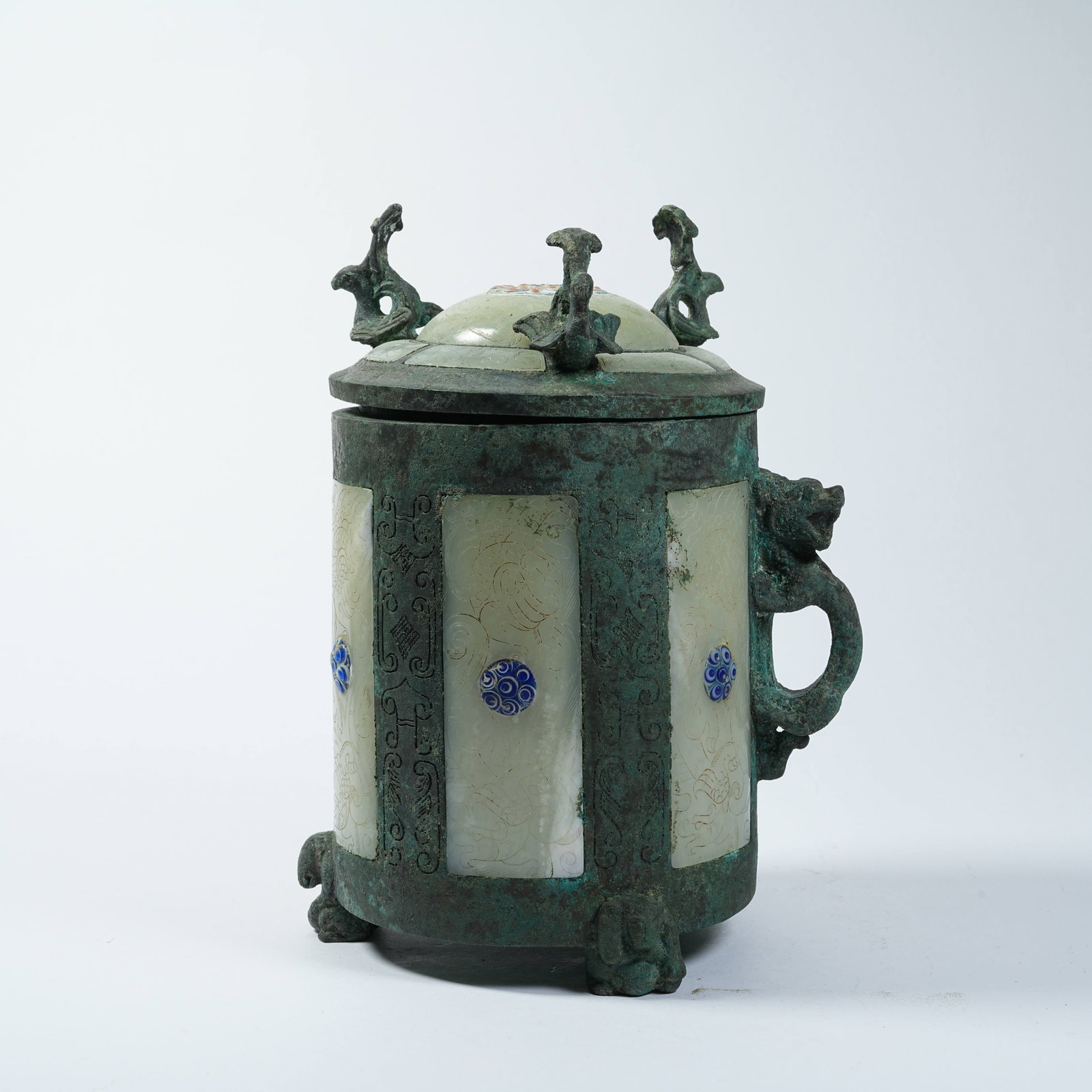A BRONZE COVERED CUP INLAID WITH GEMS AND HETIAN JADE DRAGON HANDLE: Bronze Covered Cup Inlaid with Gems and Hetian Jade Dragon Handle