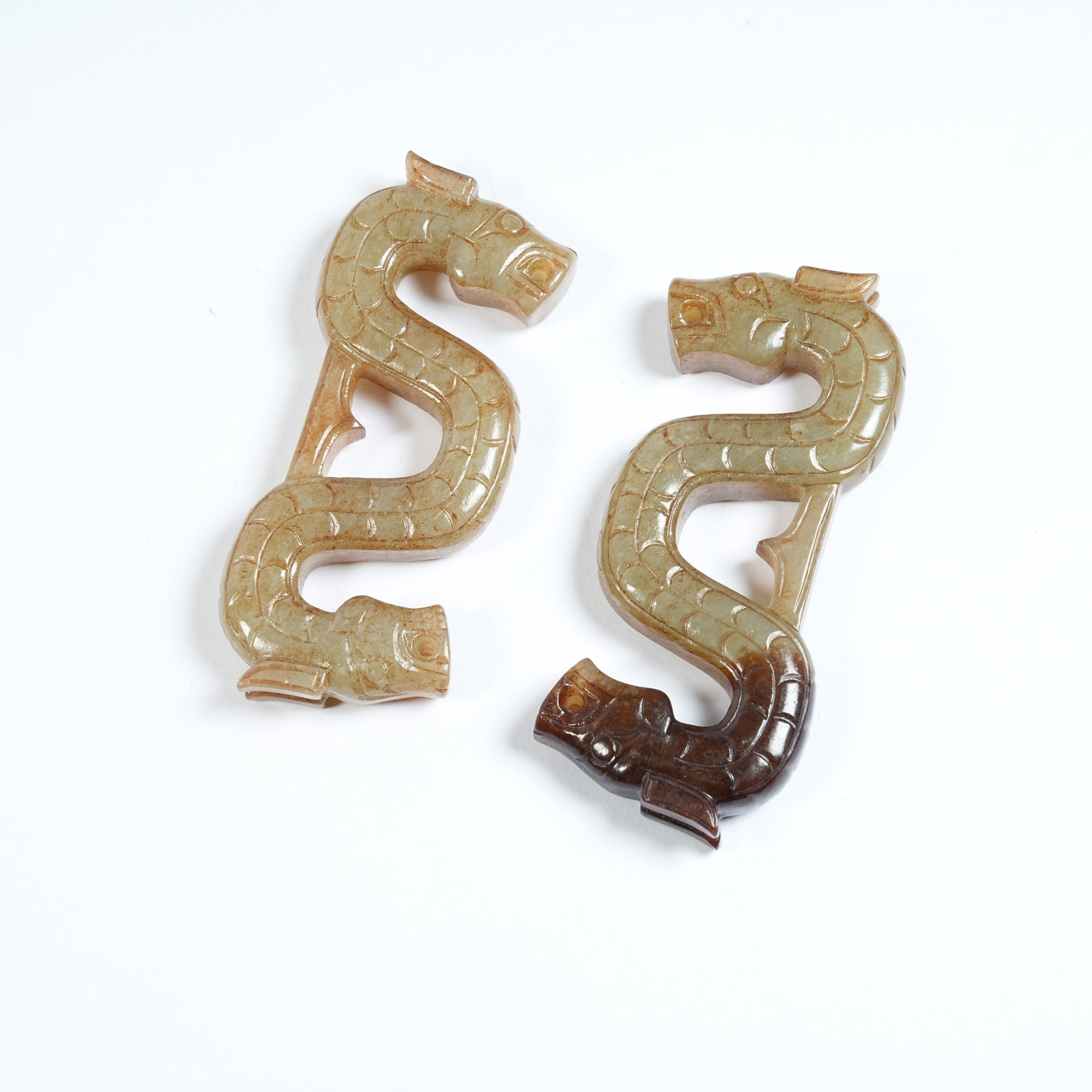 A SET OF ANCIENT JADE DOUBLE DRAGON PENDANTS: Set of Ancient Jade Double Dragon Pendants