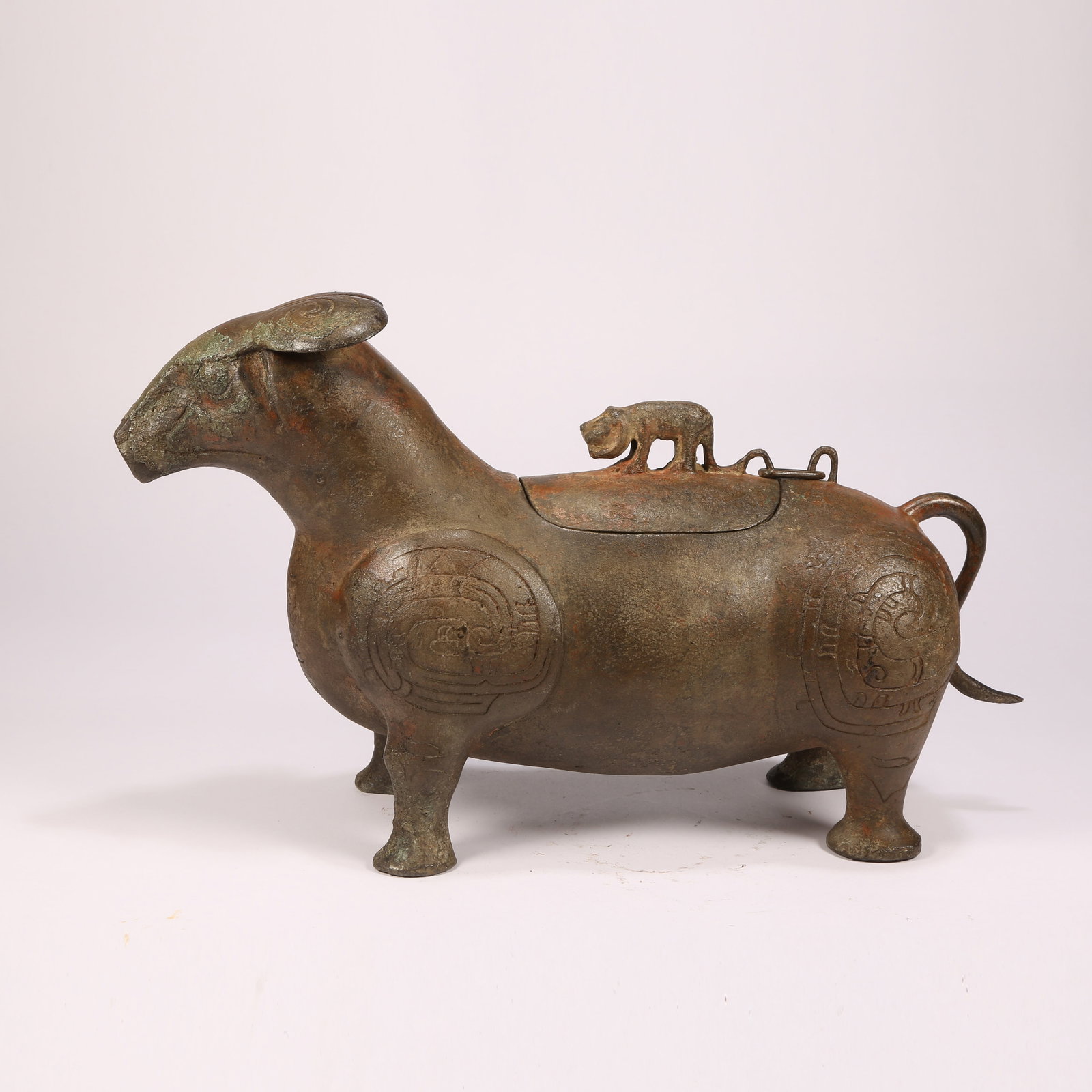 A BRONZE INCENSE BURNER IN THE FORM OF AN AUSPICIOUS BEAST: Bronze incense burner in the form of an auspicious beast