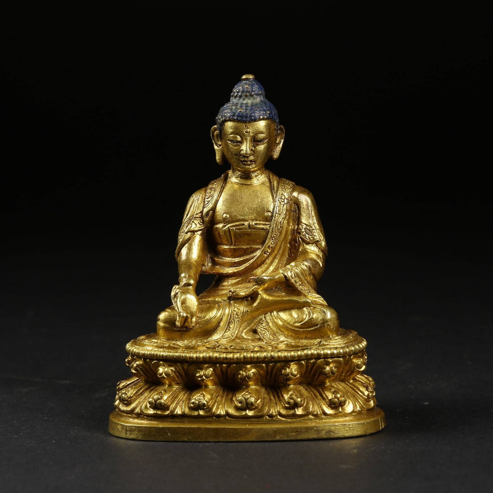 A GILT-BRONZE SHAKYAMUNI SEATED STATUE: Gilt-Bronze Shakyamuni Seated Statue
