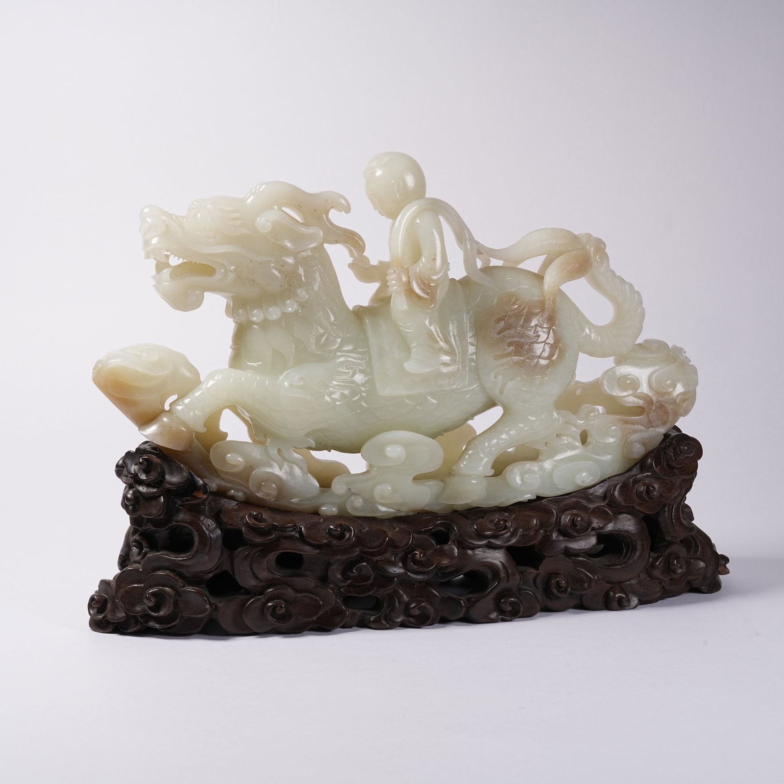 A HETIAN JADE ORNAMENT OF QILIN CARRYING FIGURE: Hetian Jade Ornament of Qilin Carrying Figure