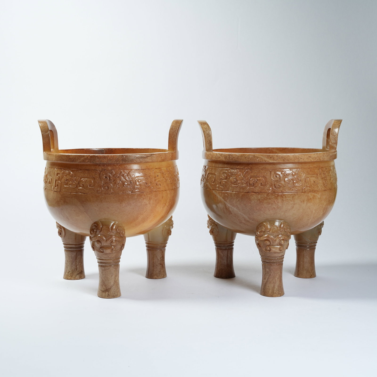 A ANCIENT JADE TRIPOD CENSER WITH BEAST MASK PATTERNS AND UPRIGHT EARS: Ancient Jade Tripod Censer with Beast Mask Patterns and Upright Ears