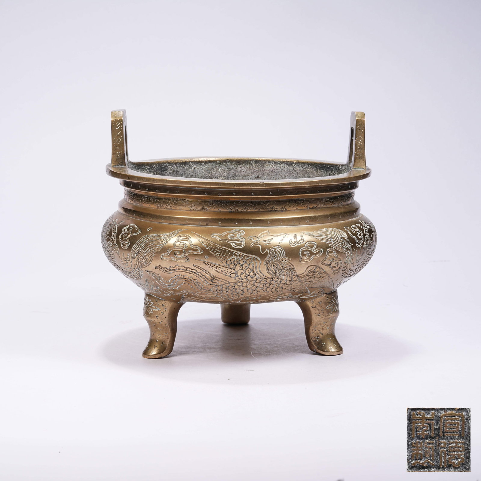 A BRONZE TRIPOD CENSER WITH UPRIGHT EARS, RIVER CLIFF, SEA WAVE AND DRAGON PATTERNS: Bronze Tripod Censer with Upright Ears, River Cliff, Sea Wave and Dragon Patterns
