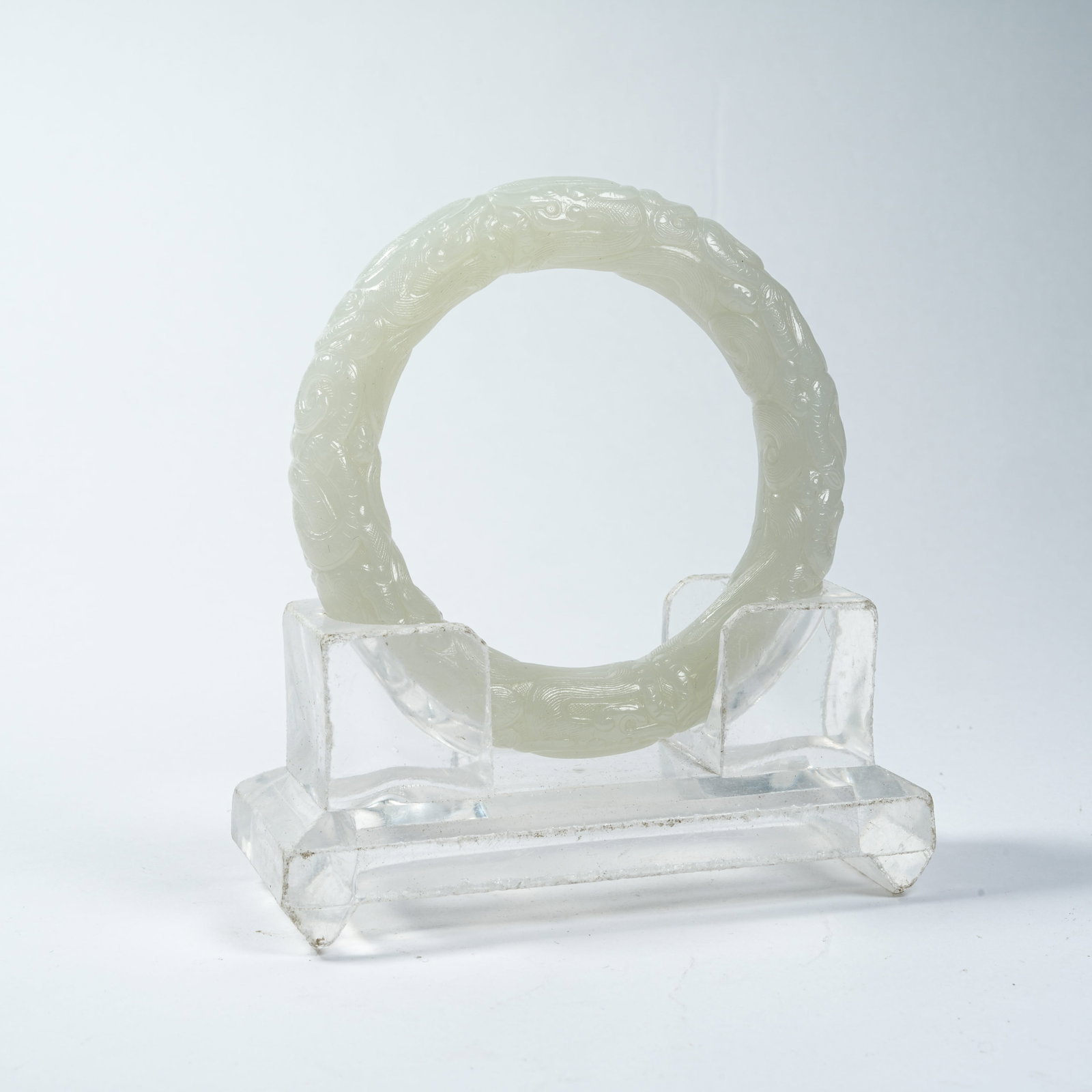 A HETIAN JADE BRACELET WITH DRAGON PATTERNS: Hetian Jade Bracelet with Dragon Patterns