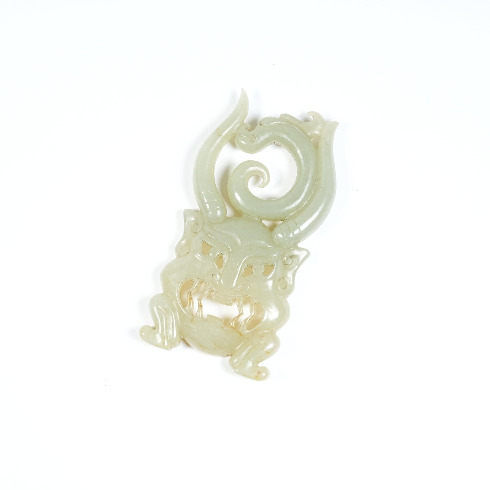A ANCIENT JADE PENDANT WITH BEAST MASK AND DRAGON PATTERNS: Ancient Jade Pendant with Beast Mask and Dragon Patterns