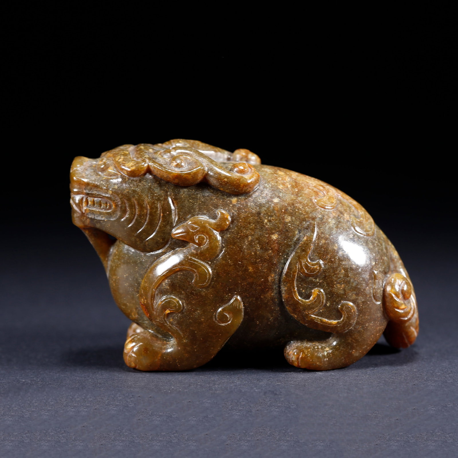 A BEAST-SHAPED CARVED HETIAN JADE ORNAMENT (1 of 9)