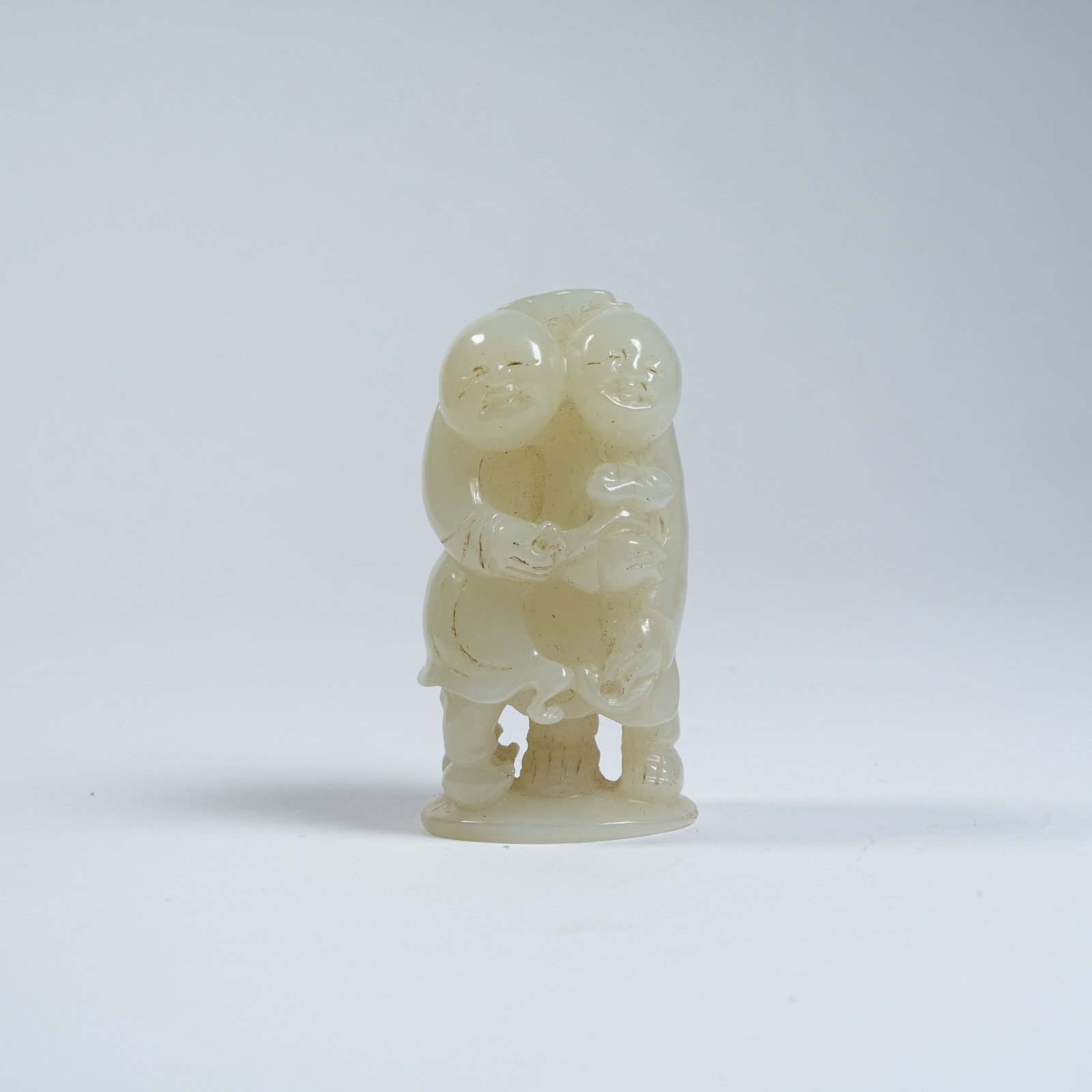 A HETIAN JADE ORNAMENT OF TWO IMMORTALS OF HARMONY (1 of 8)