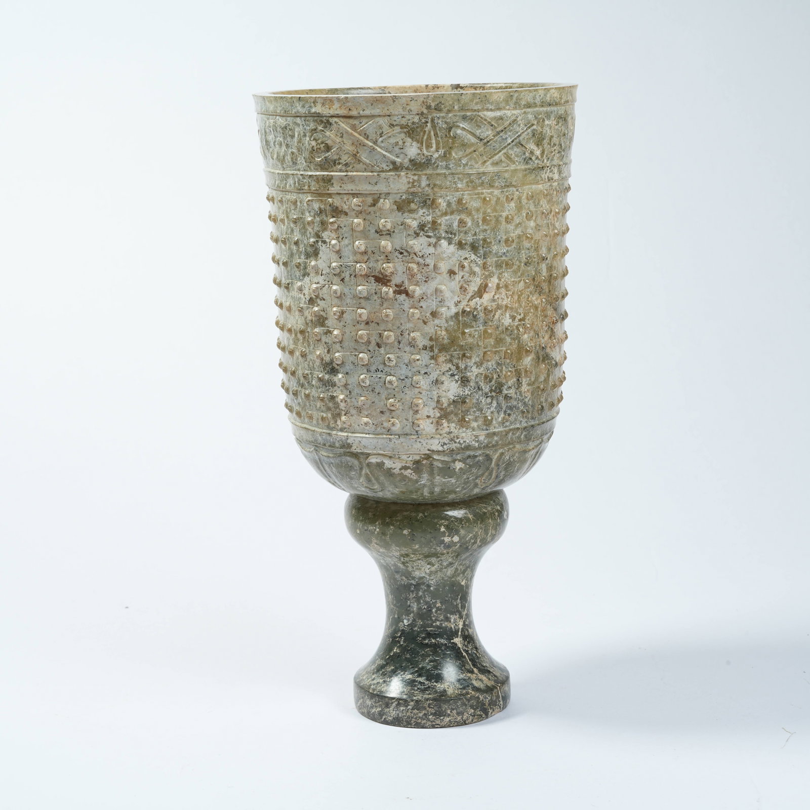 A ANCIENT JADE STEMMED CUP WITH NAIL PATTERNS (1 of 10)