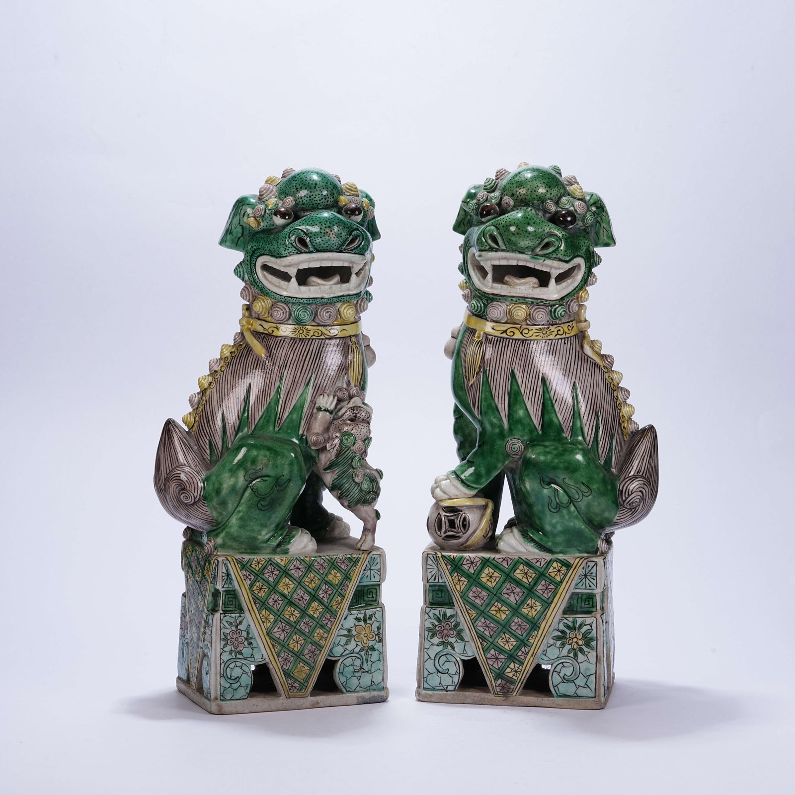 A SET OF TRI-COLOR POTTERY ORNAMENTS WITH LIONS ROLLING EMBROIDERED BALLS (1 of 10)