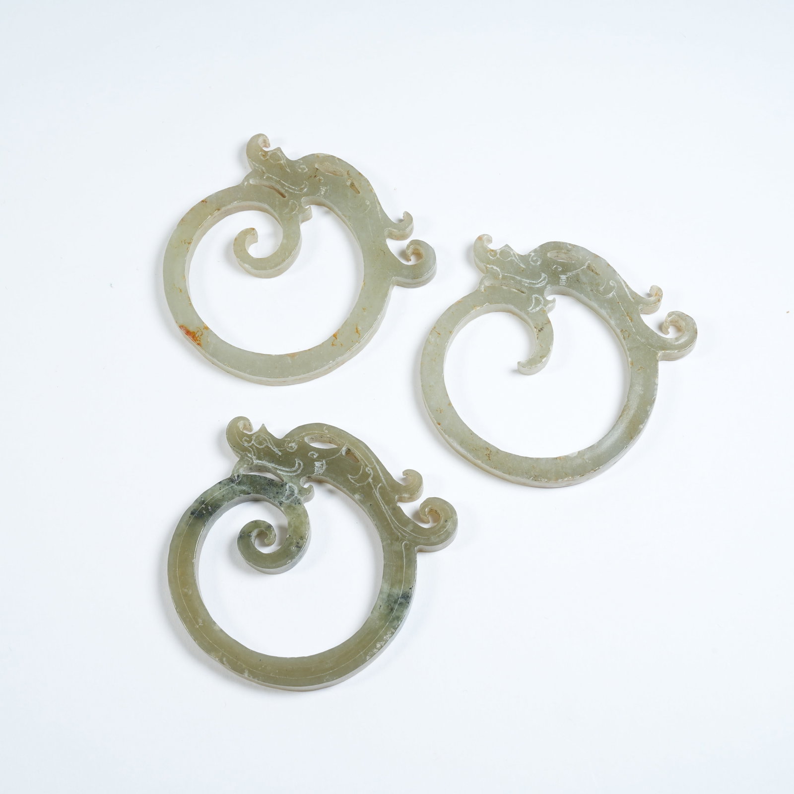 A SET OF ANCIENT JADE OUROBOROS DRAGON PENDANTS: Set of Ancient Jade Ouroboros Dragon Pendants