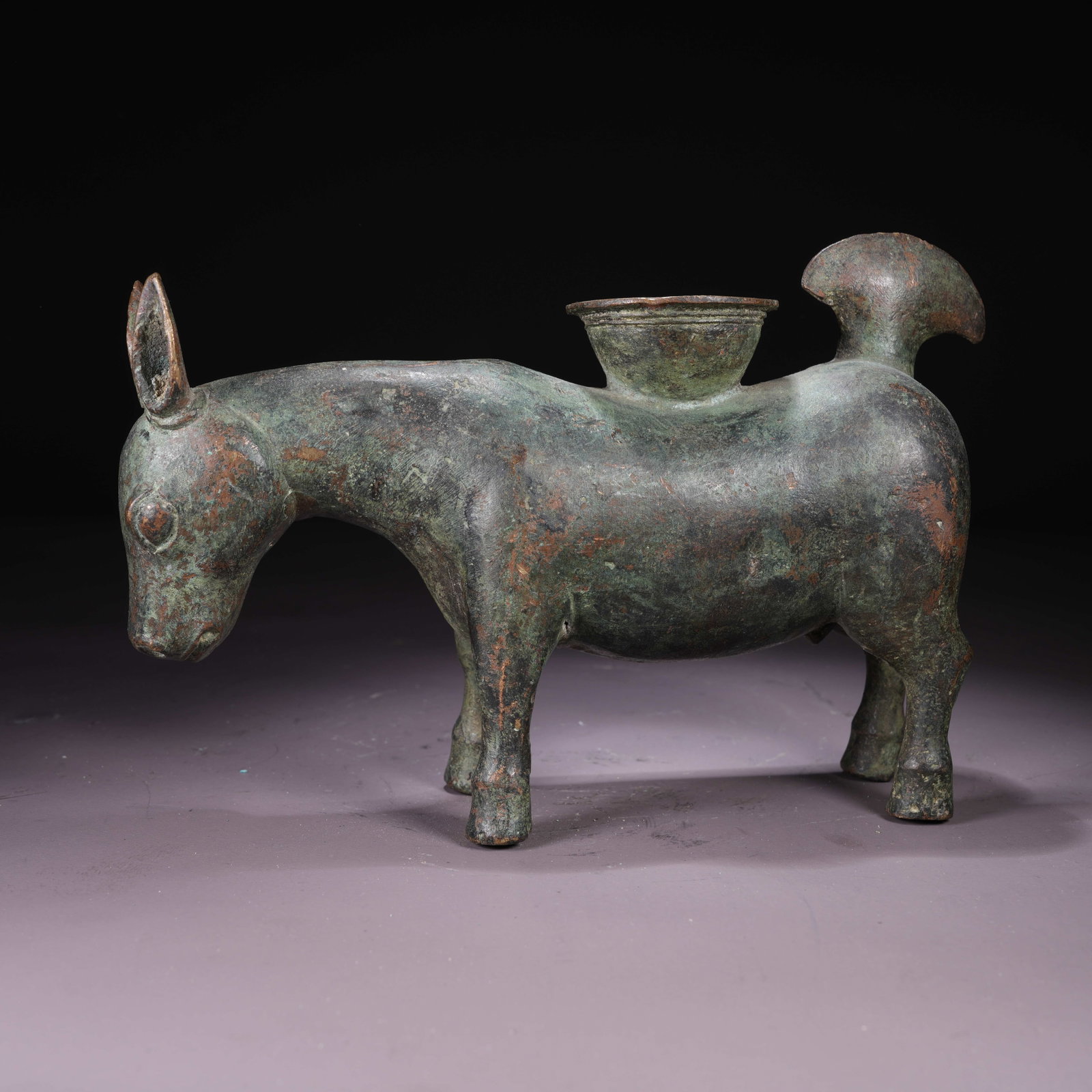 A BRONZE CANDLESTICK IN THE FORM OF AUSPICIOUS BEASTS: Bronze Candlestick in the Form of Auspicious Beasts