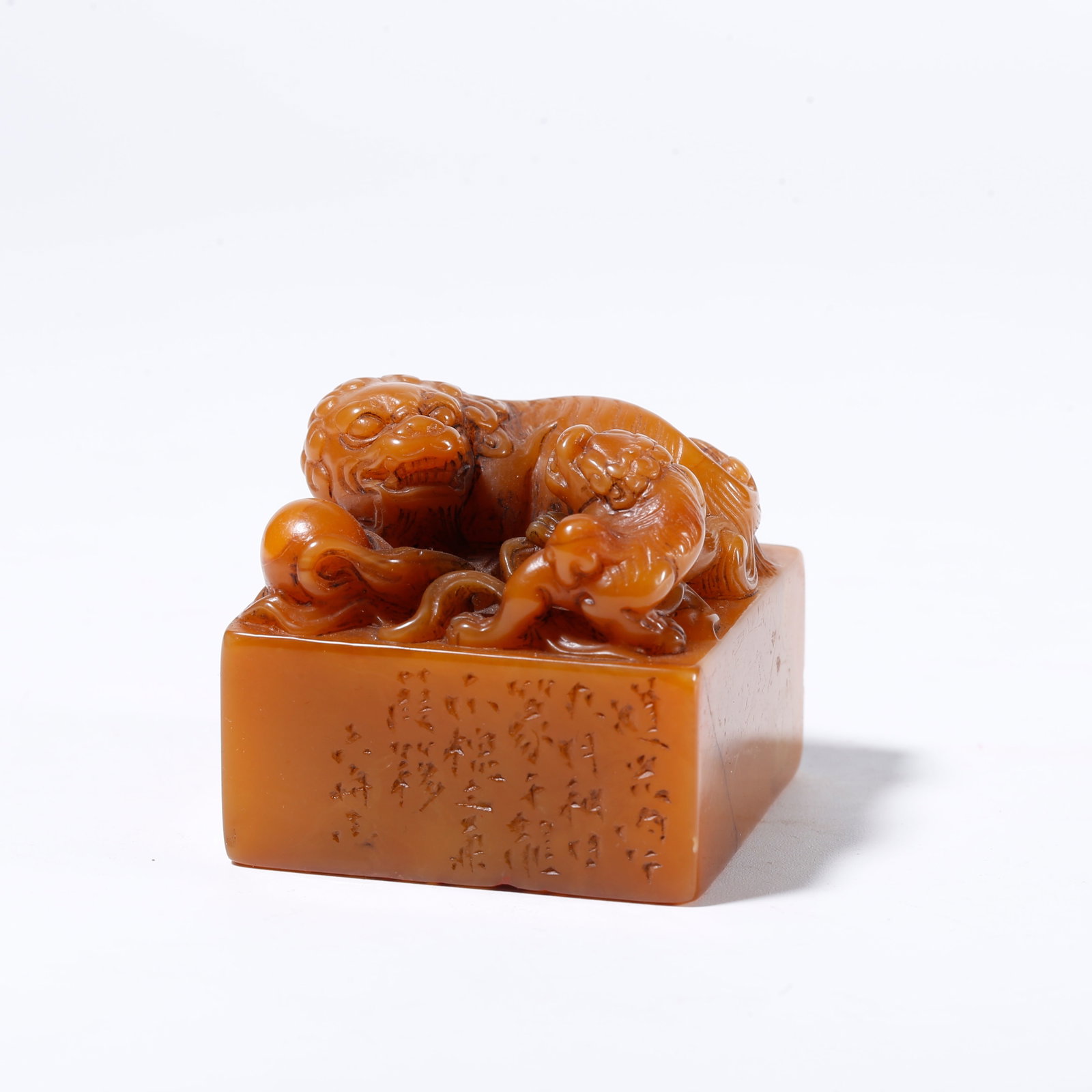 A SHOUSHAN TIANHUANG STONE SEAL WITH LION PLAYING BALL KNOB: Shoushan Tianhuang Stone Seal with Lion Playing Ball Knob
