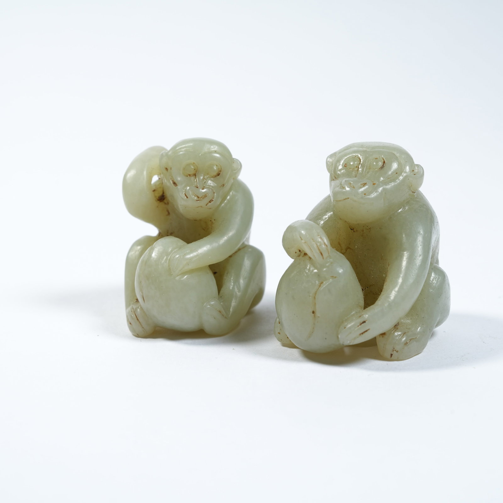A SET OF HETIAN JADE ORNAMENTS OF MONKEY PRESENTING LONGEVITY: Set of Hetian Jade Ornaments of Monkey Presenting Longevity