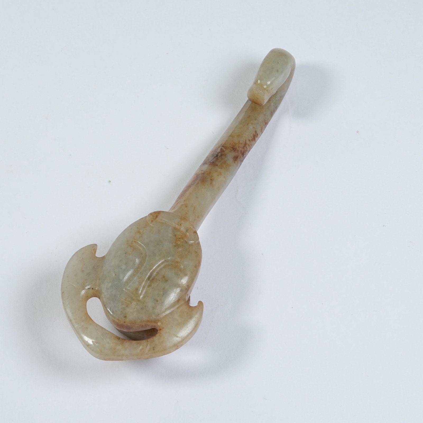 A ANCIENT JADE BELT HOOK WITH DEITY AND DRAGON HEAD: Ancient Jade Belt Hook with Deity and Dragon Head