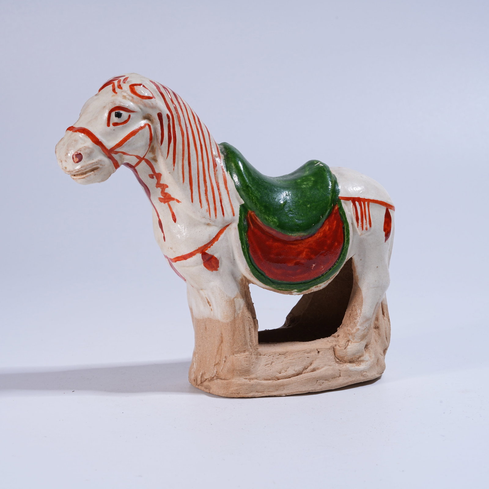 A RED-AND-GREEN GLAZED HORSE FIGURINE (1 of 8)