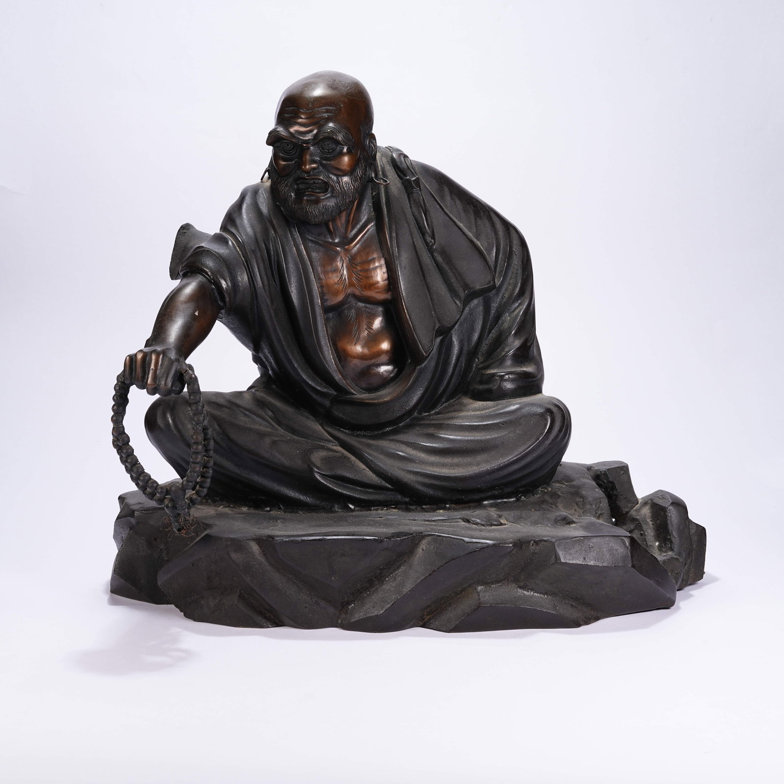 A BRONZE ARHAT ORNAMENT: Bronze Arhat Ornament