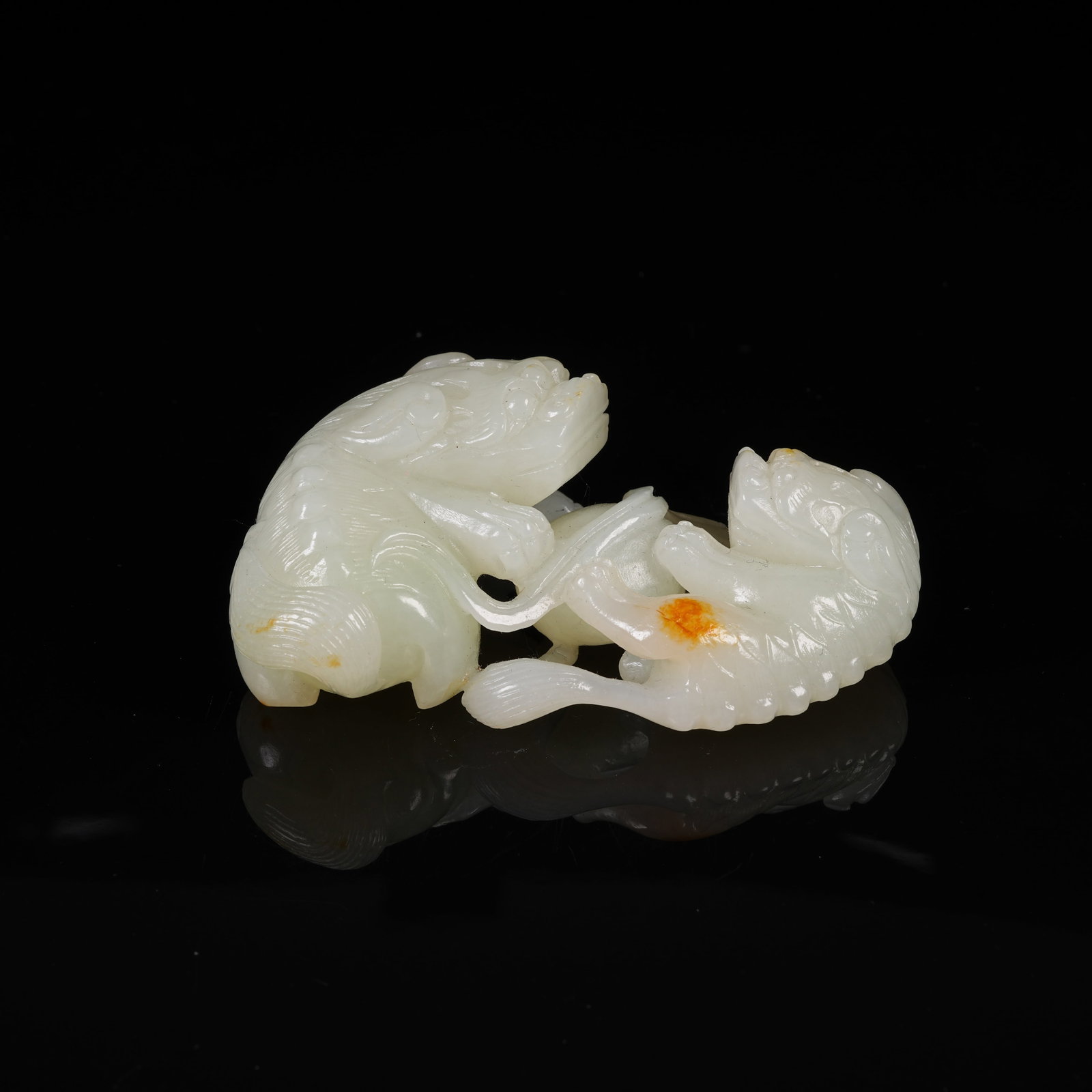 A WHITE HETIAN JADE HAND PIECE OF LION PLAYING WITH BALL: White Hetian Jade Hand Piece of Lion Playing with Ball