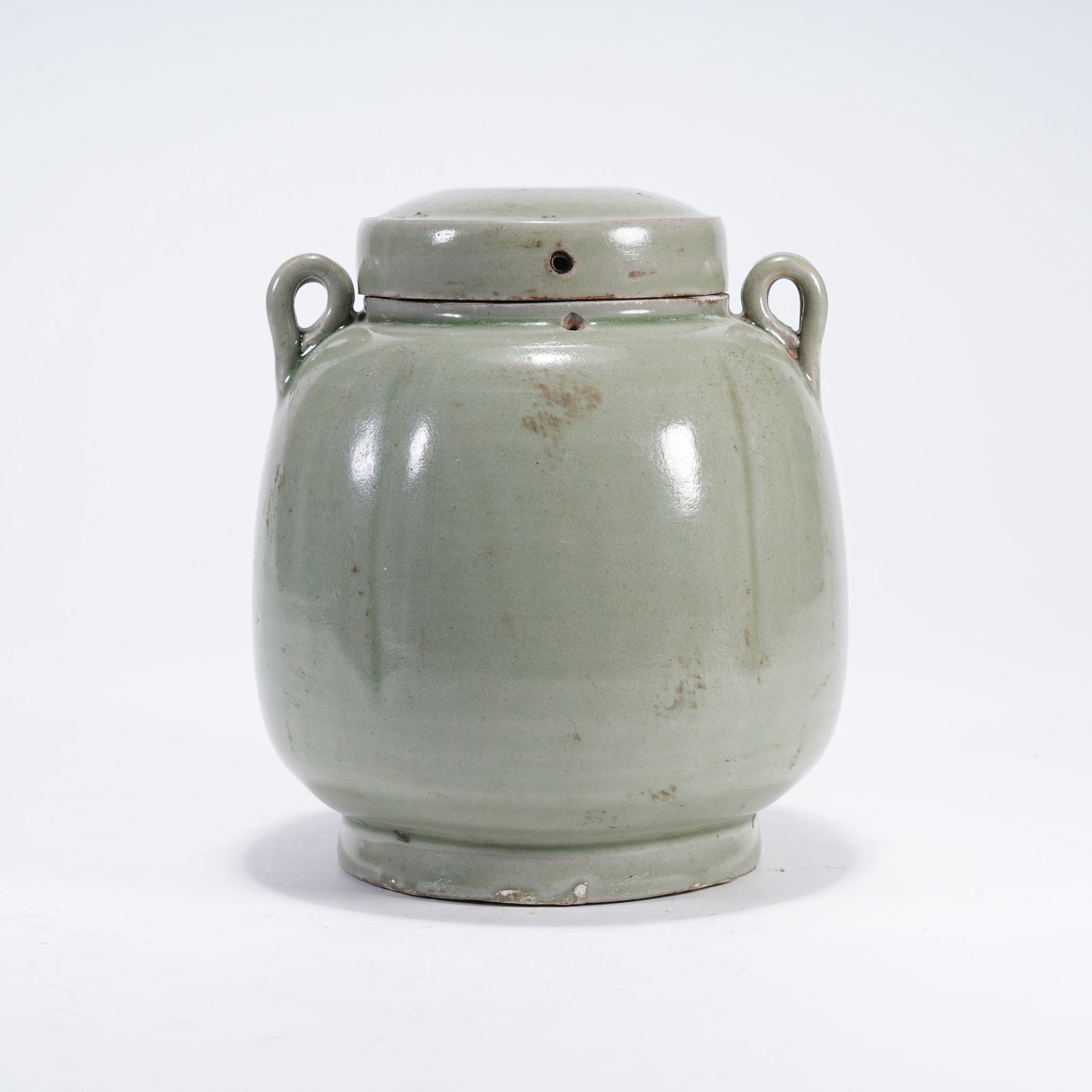 A MELON-RIBBED COVERED JAR WITH DOUBLE LOOPS UNDER CELADON GLAZE (1 of 9)