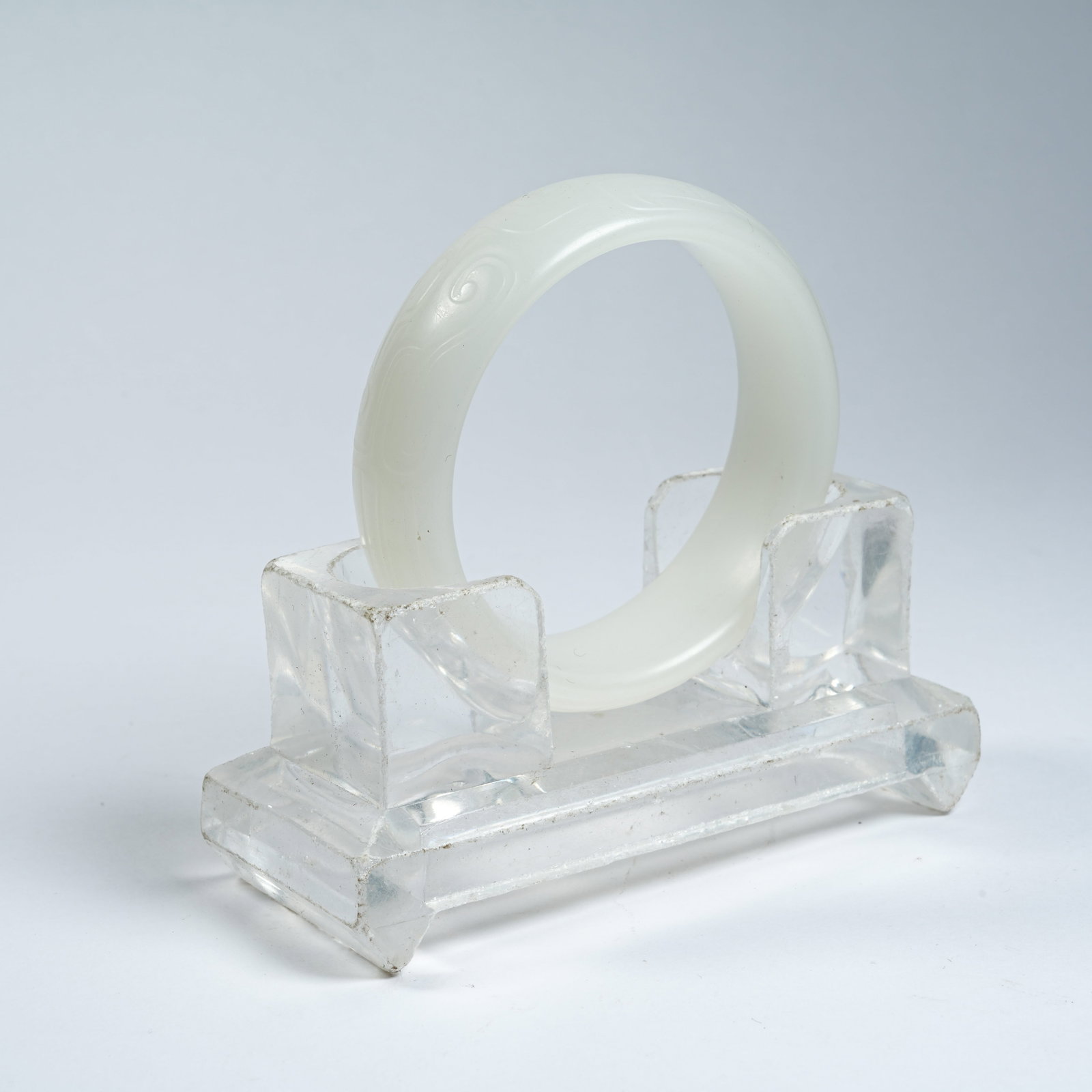 A HETIAN JADE BRACELET WITH INTERLOCKING CLOUD PATTERNS (1 of 8)