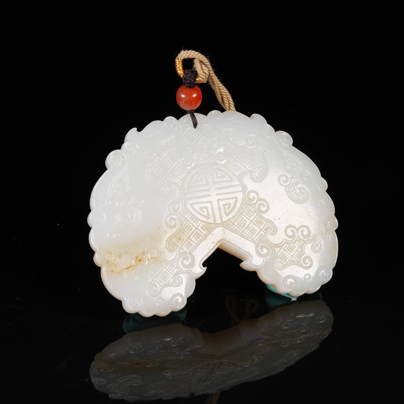 A HETIAN JADE PENDANT WITH DOUBLE DRAGONS HOLDING LONGEVITY CHARACTER: Hetian Jade Pendant with Double Dragons Holding Longevity Character