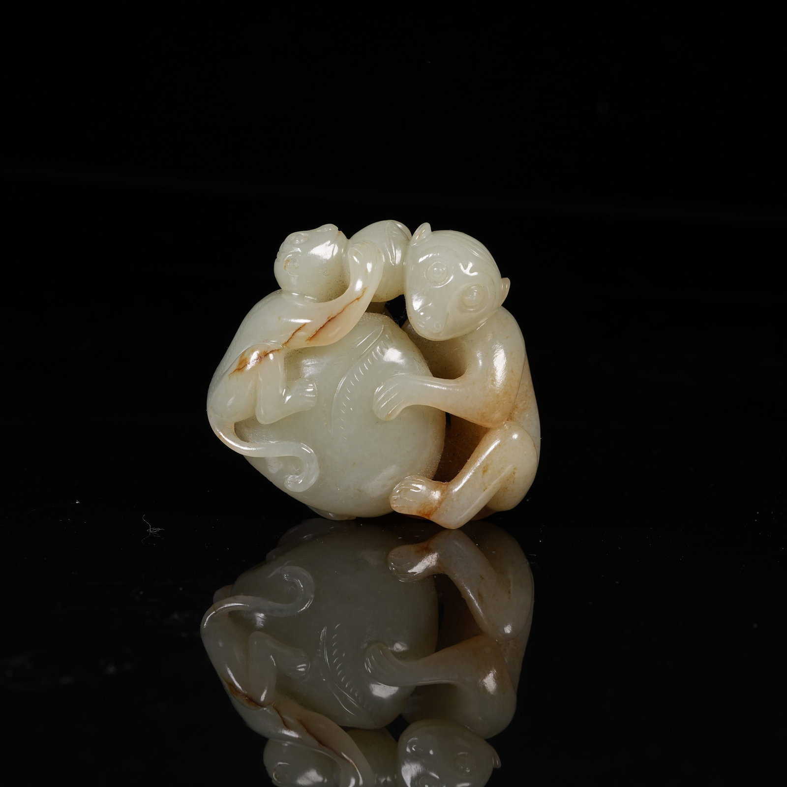 A HETIAN JADE ORNAMENT OF MONKEY PRESENTING LONGEVITY BLESSINGS: Hetian Jade Ornament of Monkey Presenting Longevity Blessings
