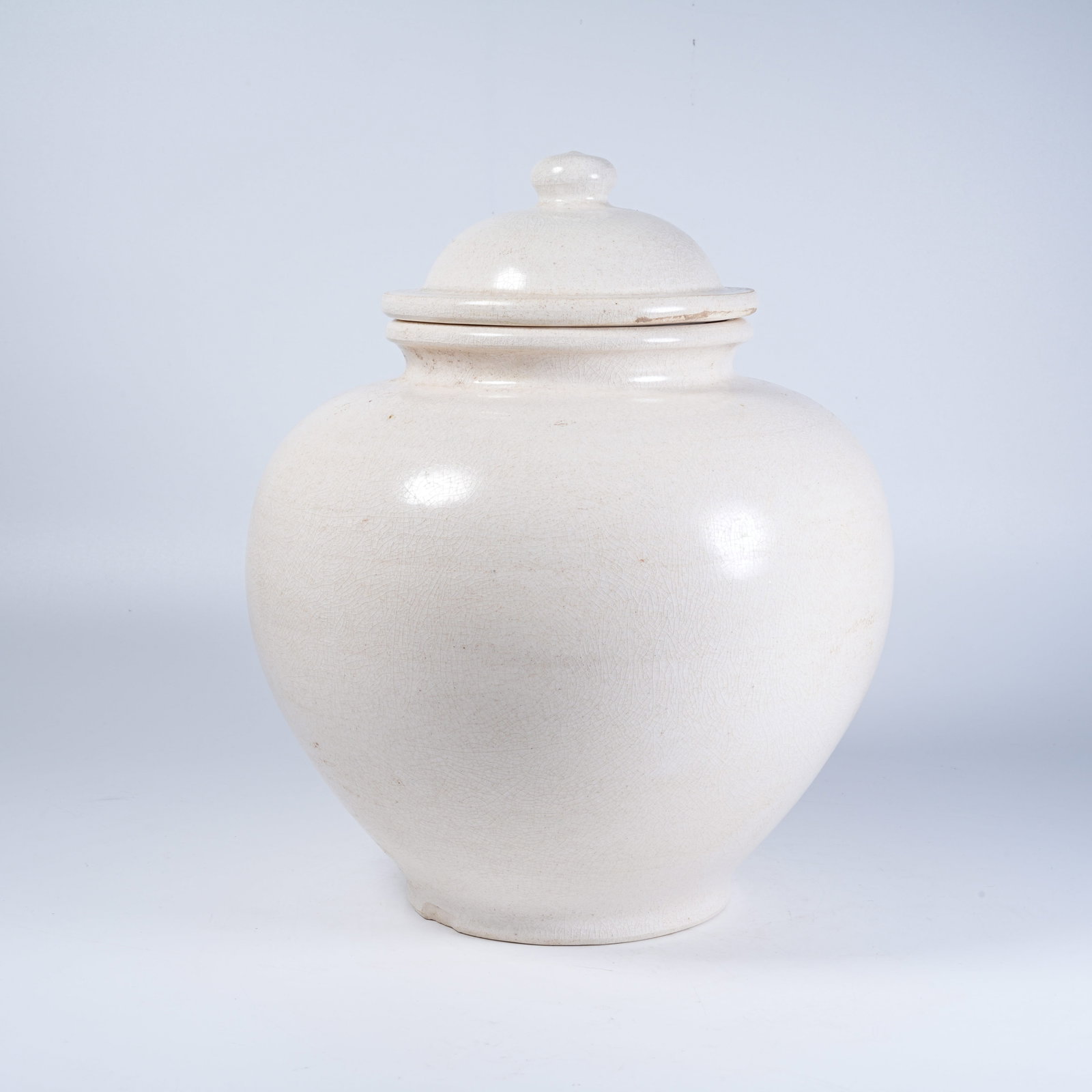 A WHITE GLAZE COVERED JAR (1 of 9)