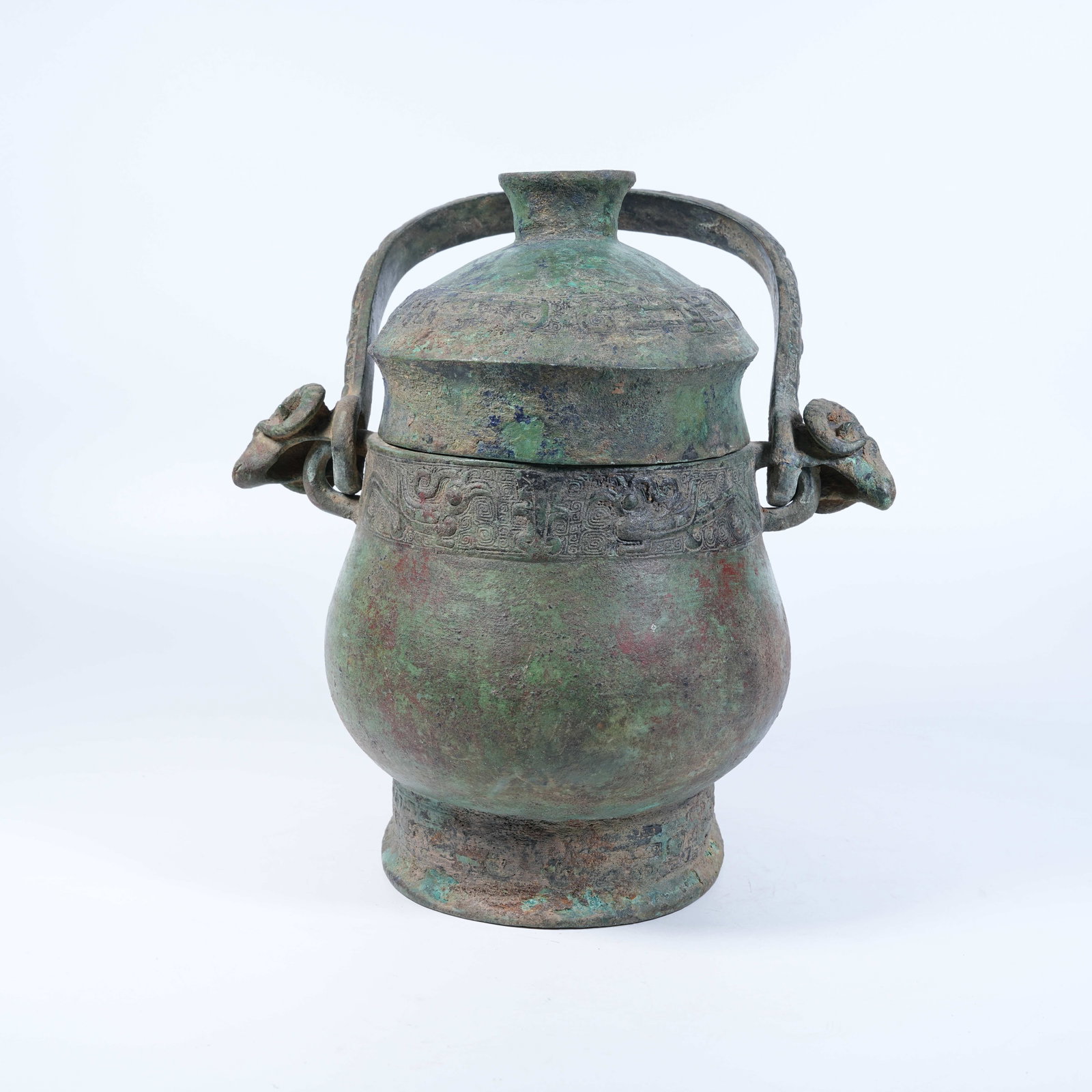 A BRONZE YOU WINE VESSEL WITH SHEEP HEAD SPOUTS AND LOOP HANDLE (1 of 9)