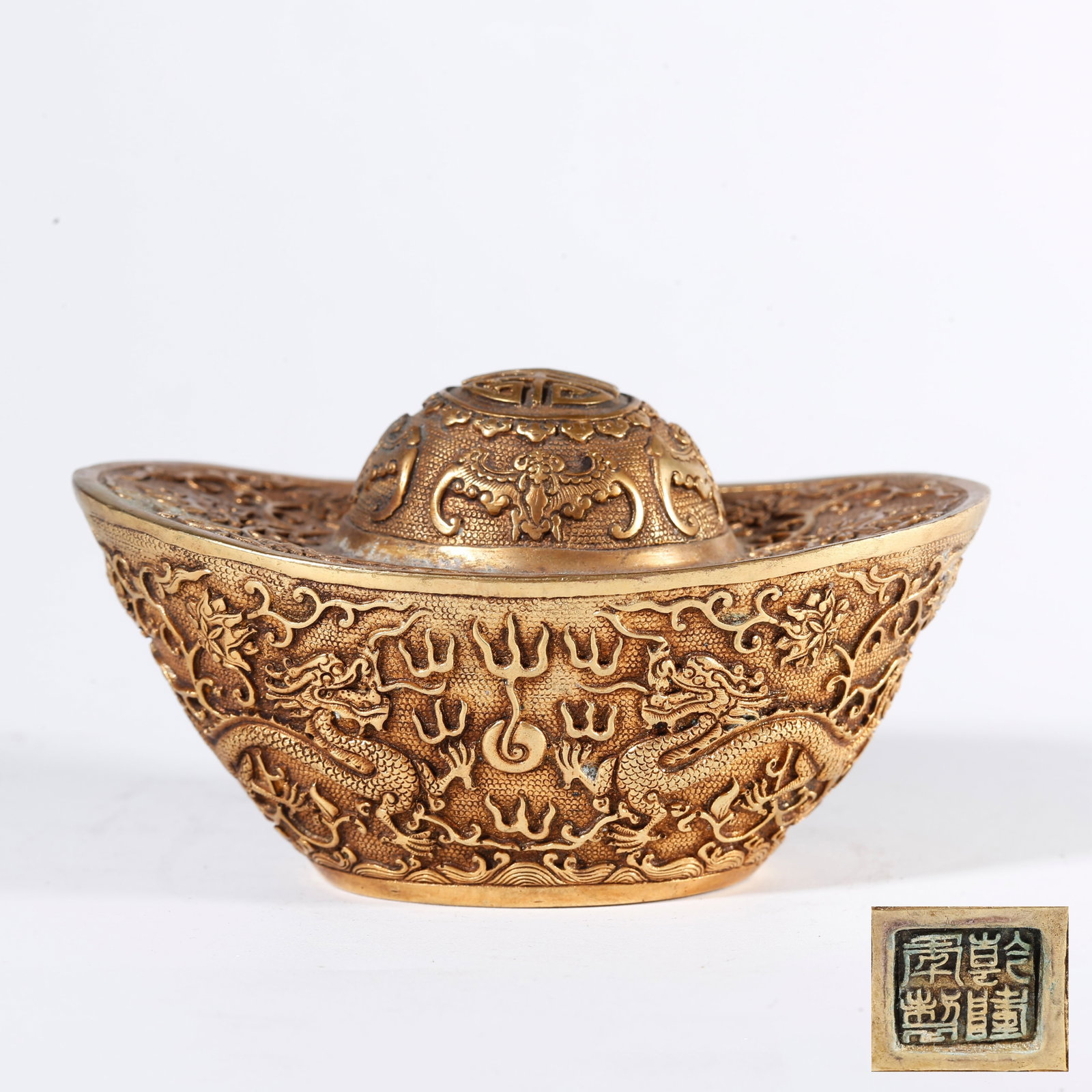 A GILT BRONZE INGOT WITH FIVE BLESSINGS EMBRACING LONGEVITY PATTERN: Gilt Bronze Ingot with Five Blessings Embracing Longevity Pattern