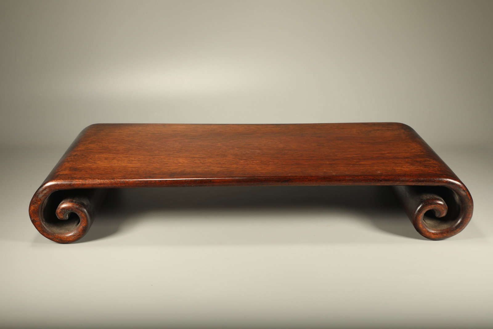A PADAUK LOWER SCROLL SIDE TABLE: Padauk Lower Scroll Side Table