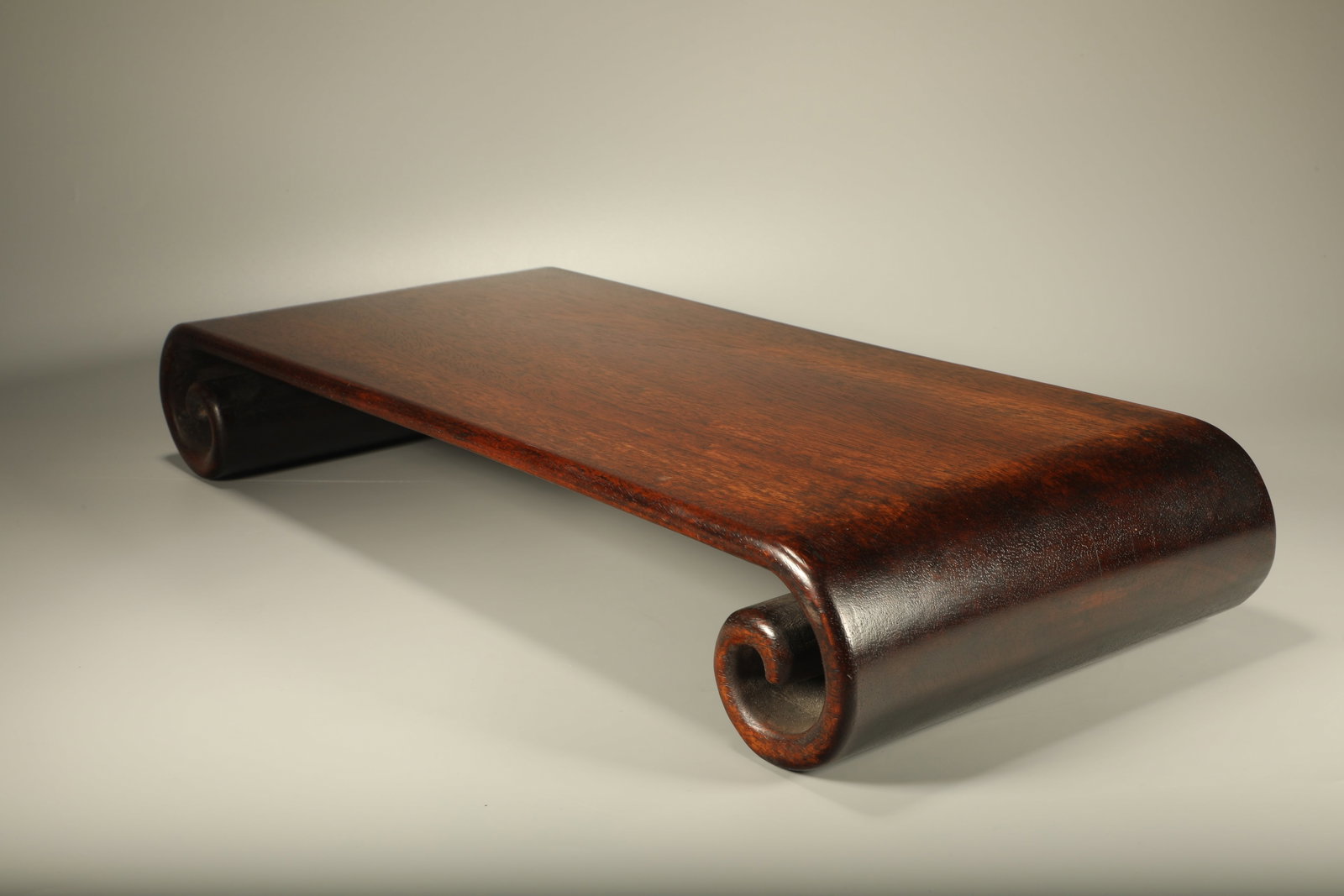 A PADAUK LOWER SCROLL SIDE TABLE - 2