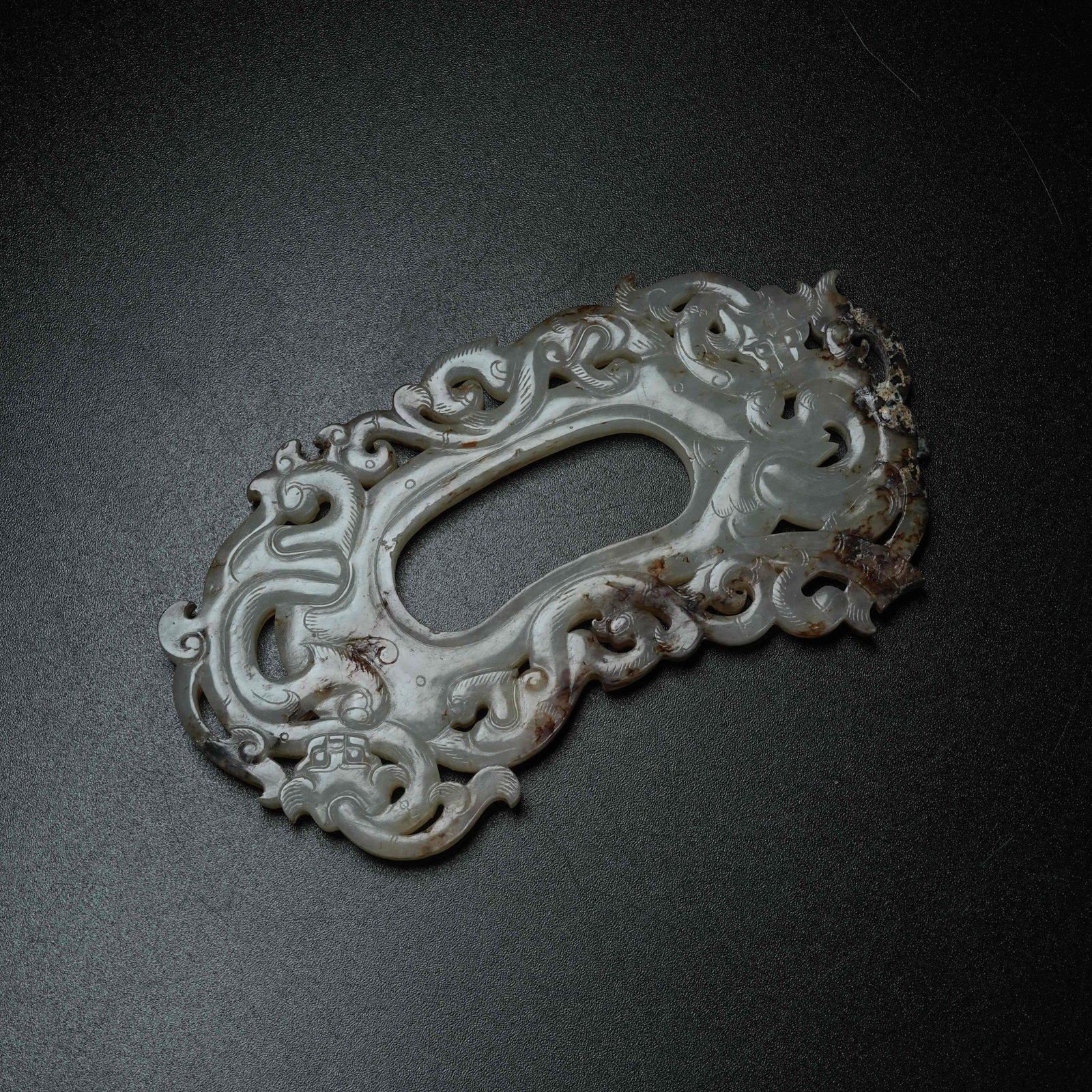 A ARCHAIC JADE HEART-SHAPED PENDANT WITH CHI DRAGON PATTERN: Archaic Jade Heart-shaped Pendant with Chi Dragon Pattern