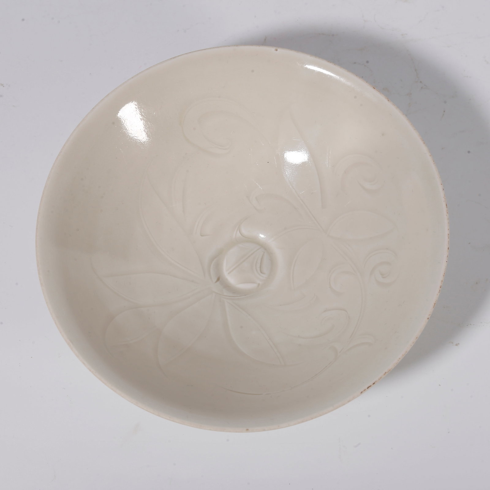 A DING KILN INCISED FLORAL TEA BOWL: Ding kiln incised floral tea bowl