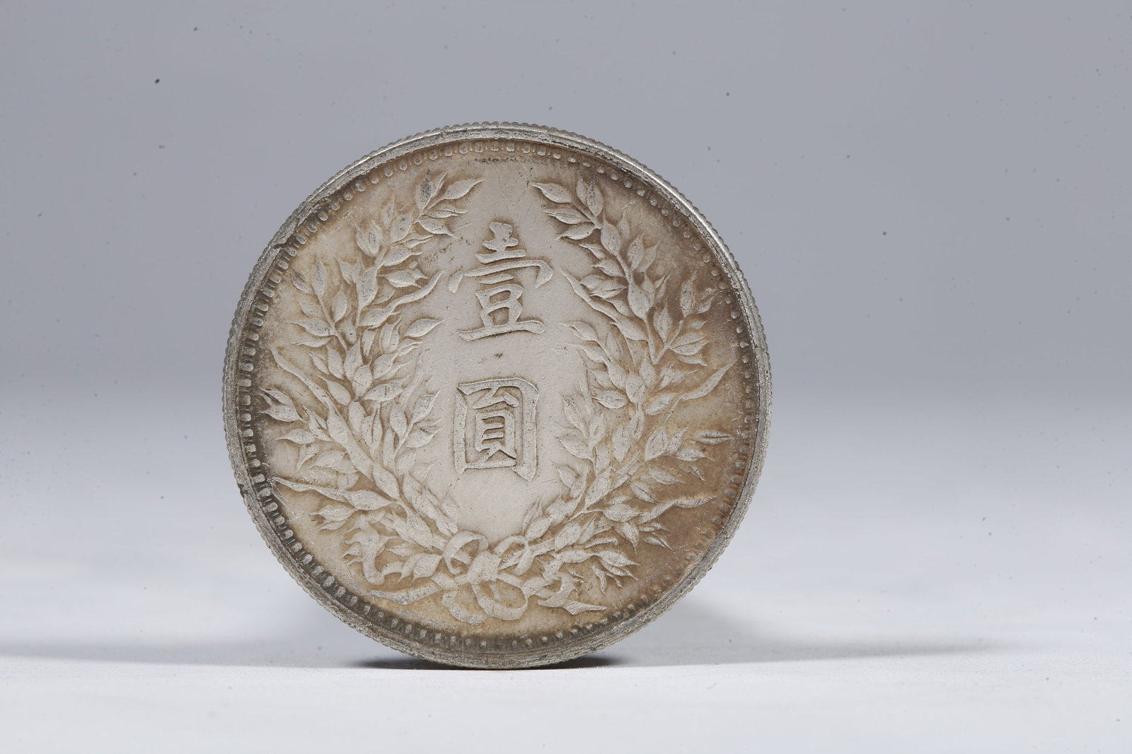 A SILVER DOLLAR COIN - 3