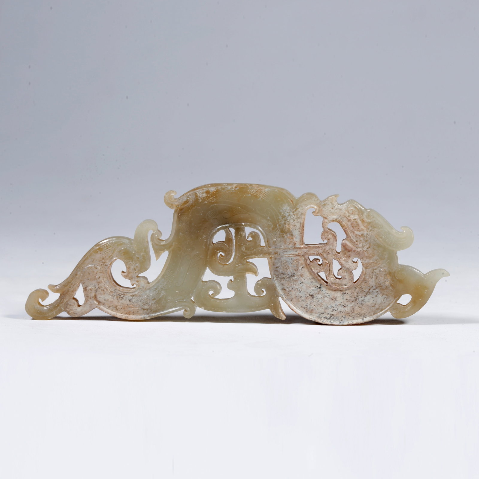 A CARVED DRAGON-SHAPED PENDANT OF ARCHAIC JADE: Carved Dragon-Shaped Pendant of Archaic Jade