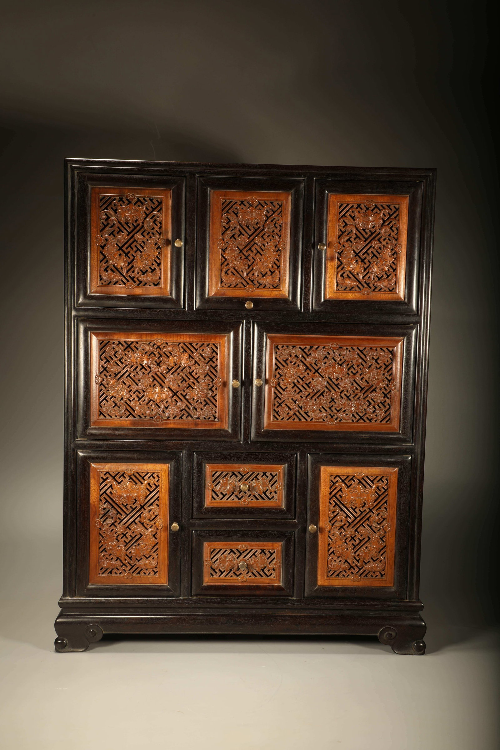 A SANDALWOOD CURIO CABINET INLAID WITH GOLDEN NANMU CARVED WITH BLESSING MOTIFS: Sandalwood Curio Cabinet Inlaid with Golden Nanmu Carved with Blessing Motifs