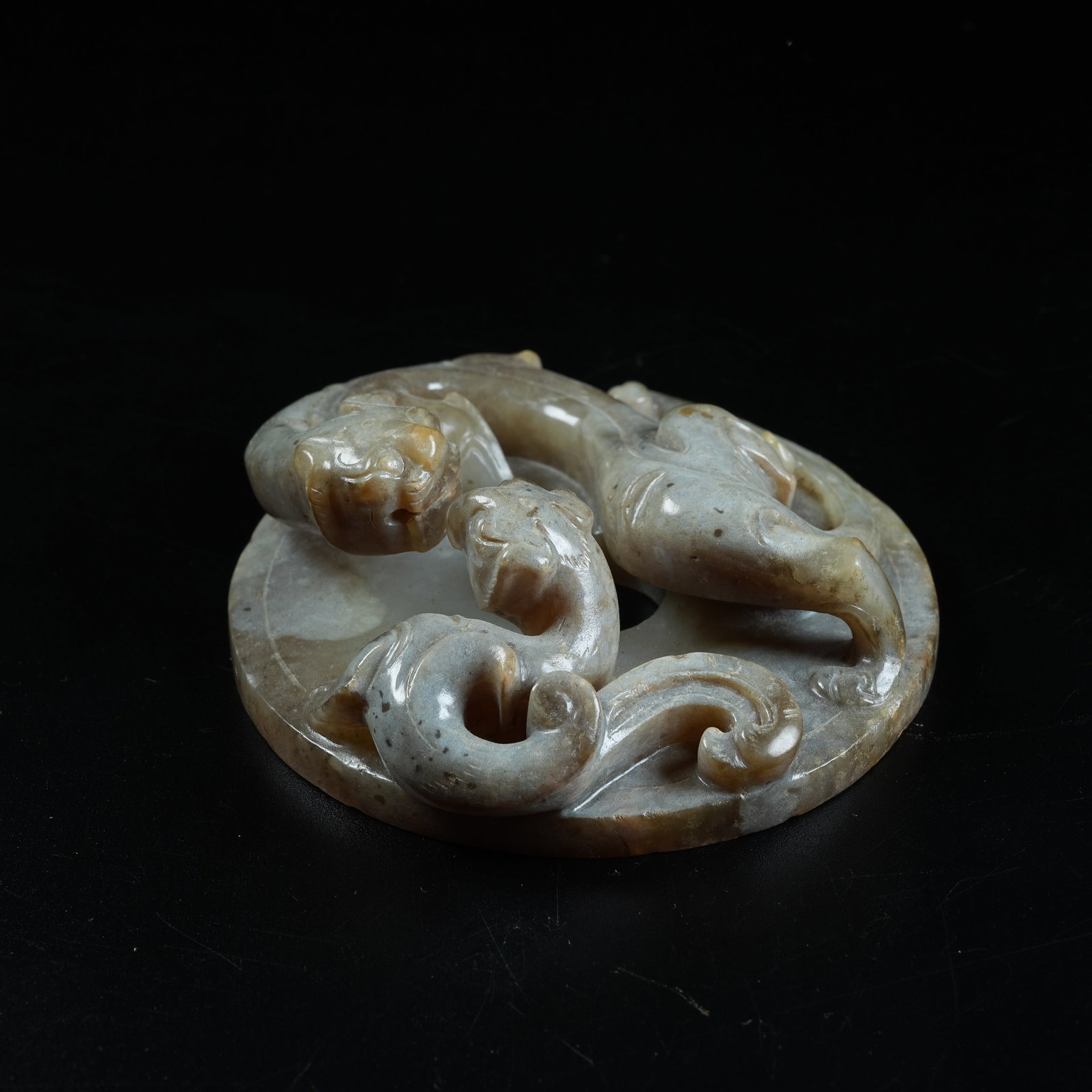 A ANCIENT JADE BI DISC CARVED WITH CHI DRAGON PATTERNS (1 of 8)