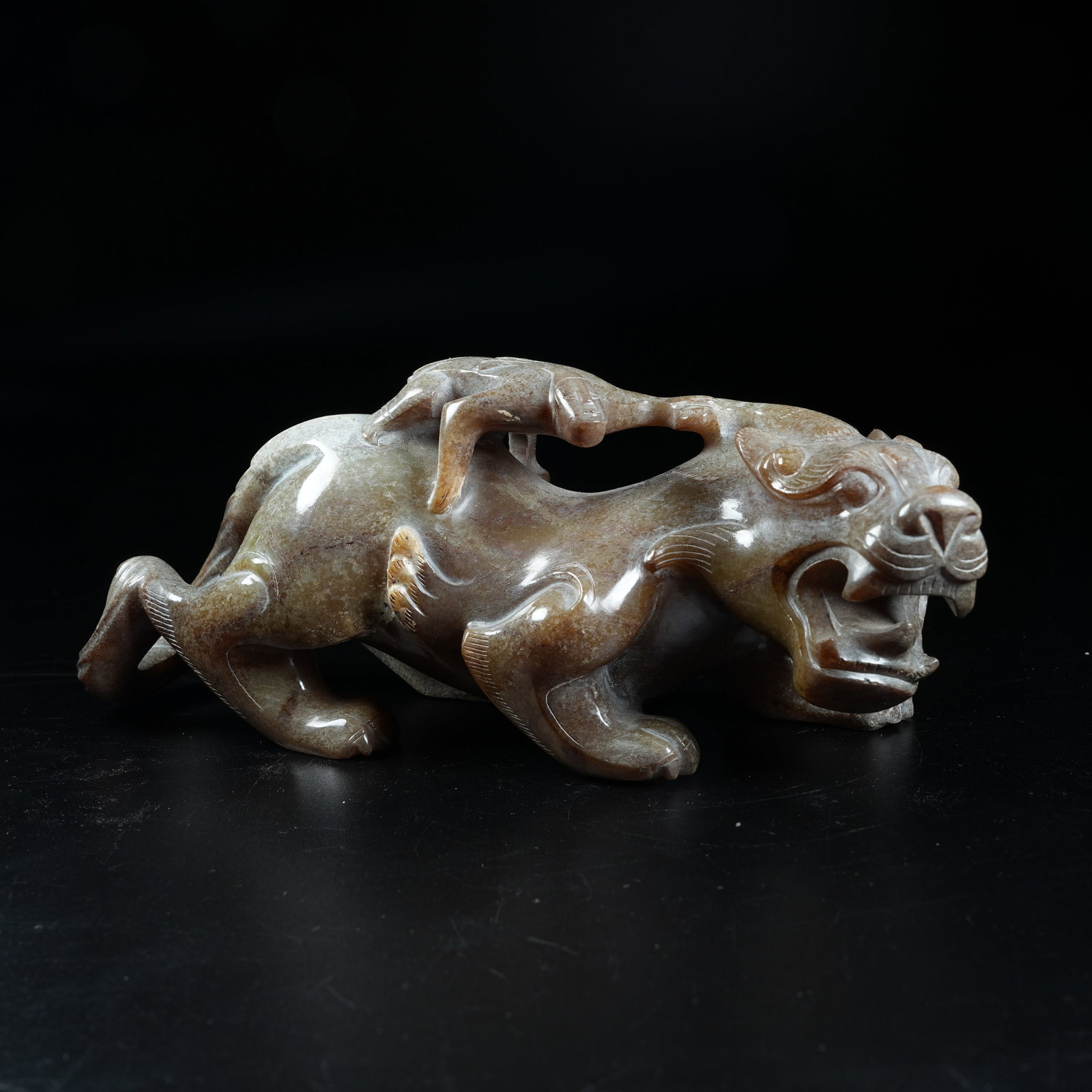 A ANCIENT JADE ORNAMENT OF FEATHERED MAN RIDING DIVINE BEAST: Ancient Jade Ornament of Feathered Man Riding Divine Beast
