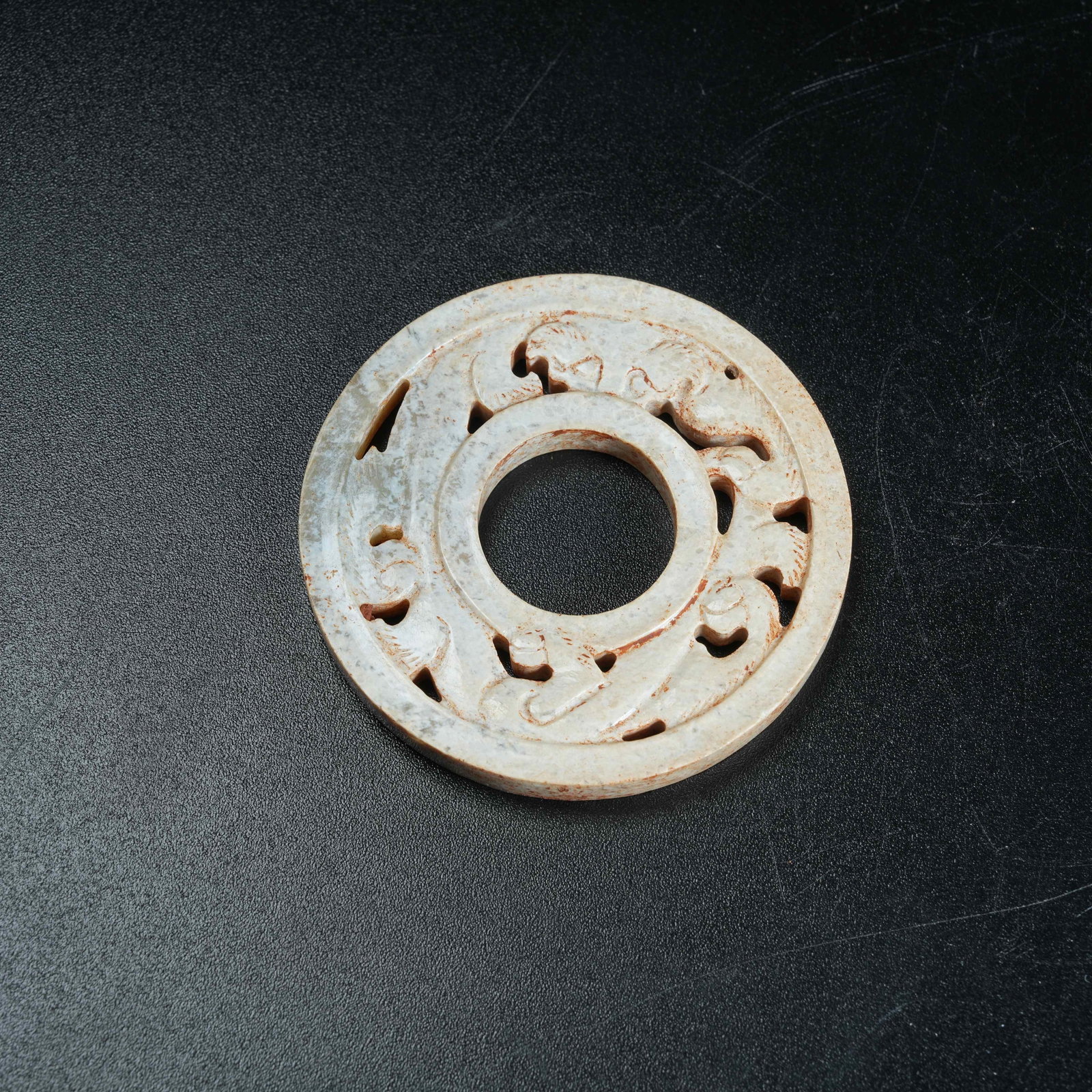 A ANCIENT JADE BI DISC CARVED WITH DRAGON PATTERNS: Ancient Jade Bi Disc Carved with Dragon Patterns