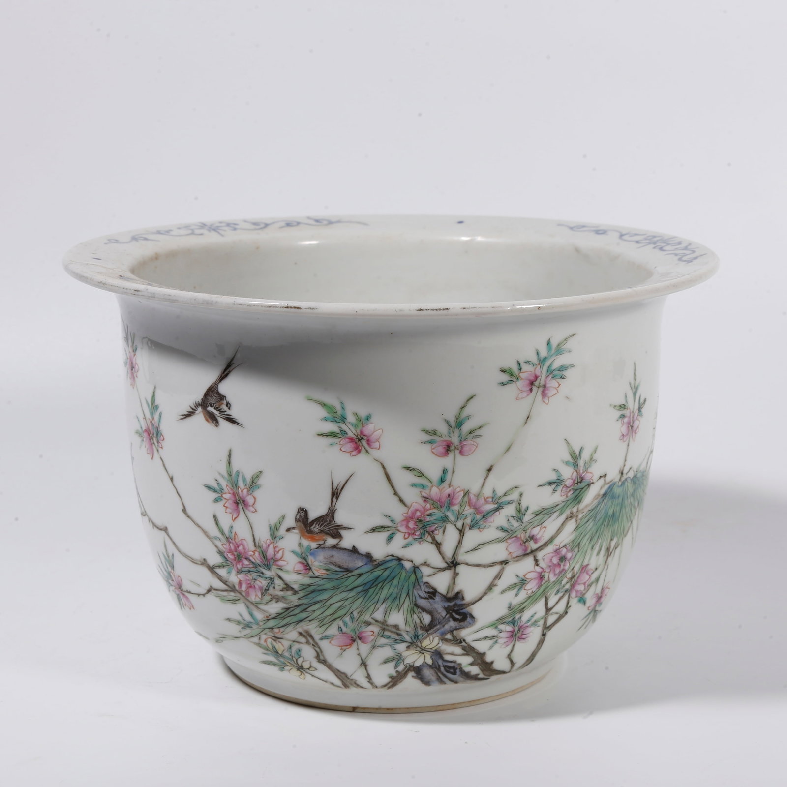 A FLOWER POT WITH FAMILLE-ROSE SPRING-SWALLOW MOTIF: Flower pot with famille-rose spring-swallow motif