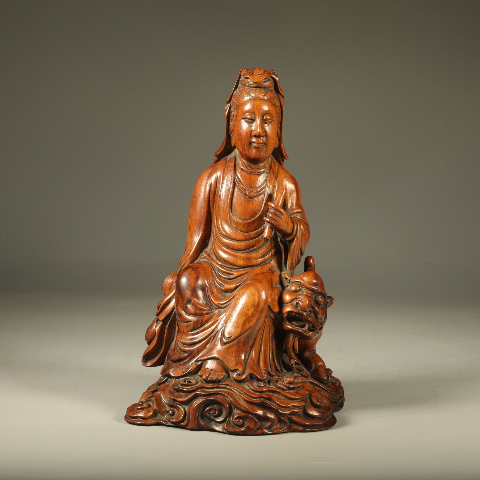 A SEATED HUANGHUALI STATUE OF AVALOKITESVARA: Seated Huanghuali Statue of Avalokitesvara