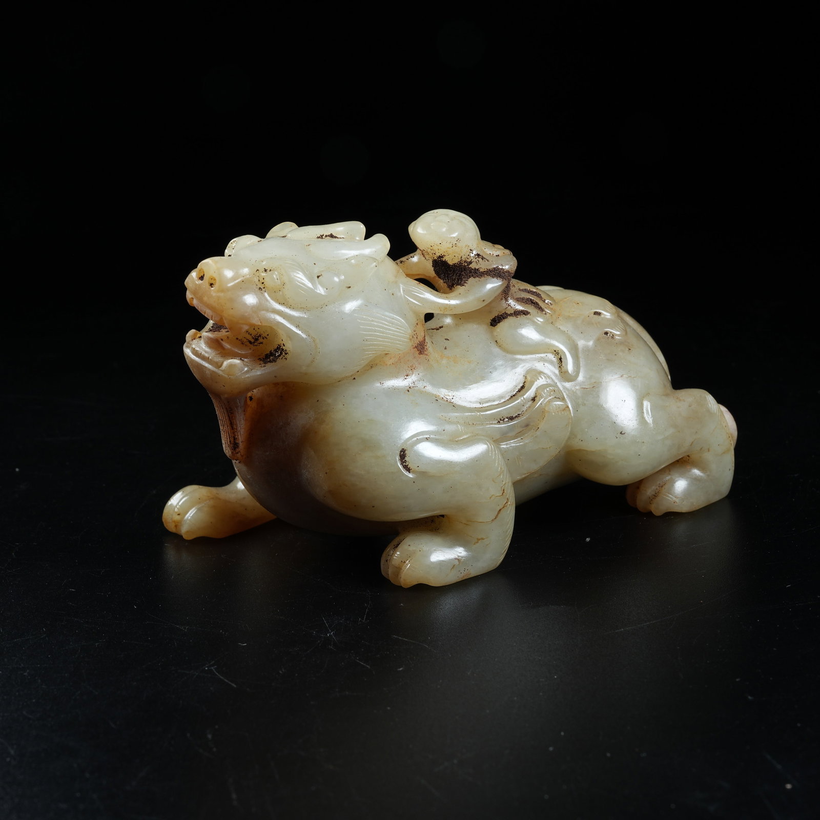 A ANCIENT JADE WINGED FIGURE RIDING BEAST ORNAMENT: Ancient Jade Winged Figure Riding Beast Ornament